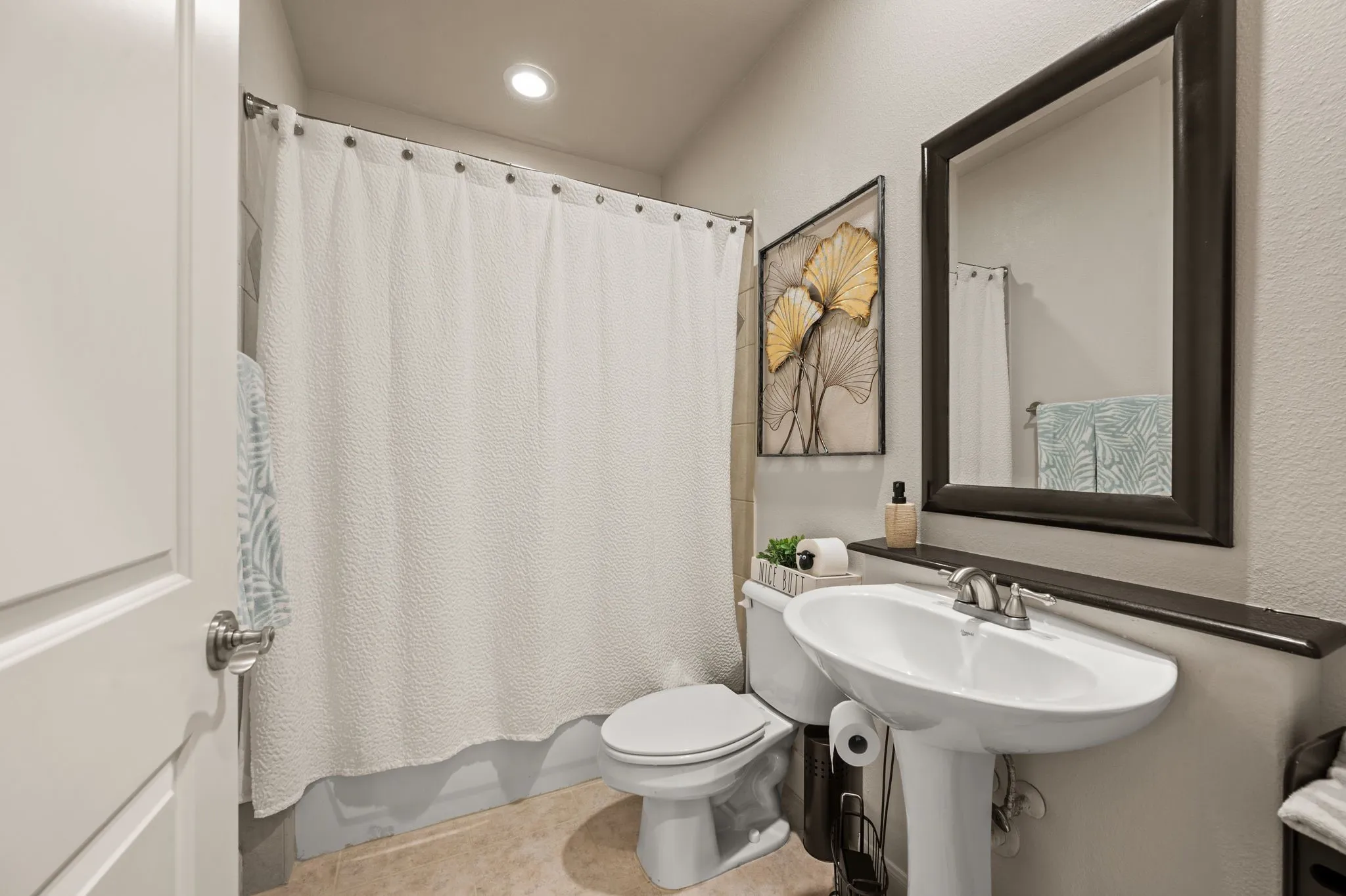 Bathroom featuring shower / tub combo with curtain and recessed lighting