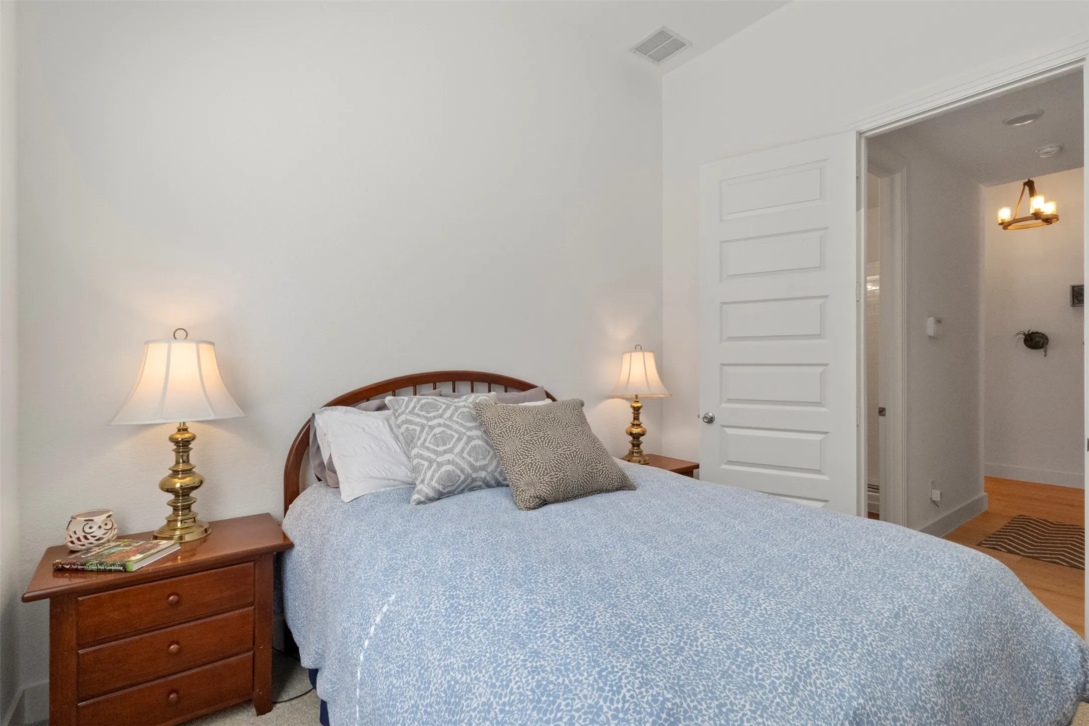 Bedroom with a chandelier and light wood-type flooring