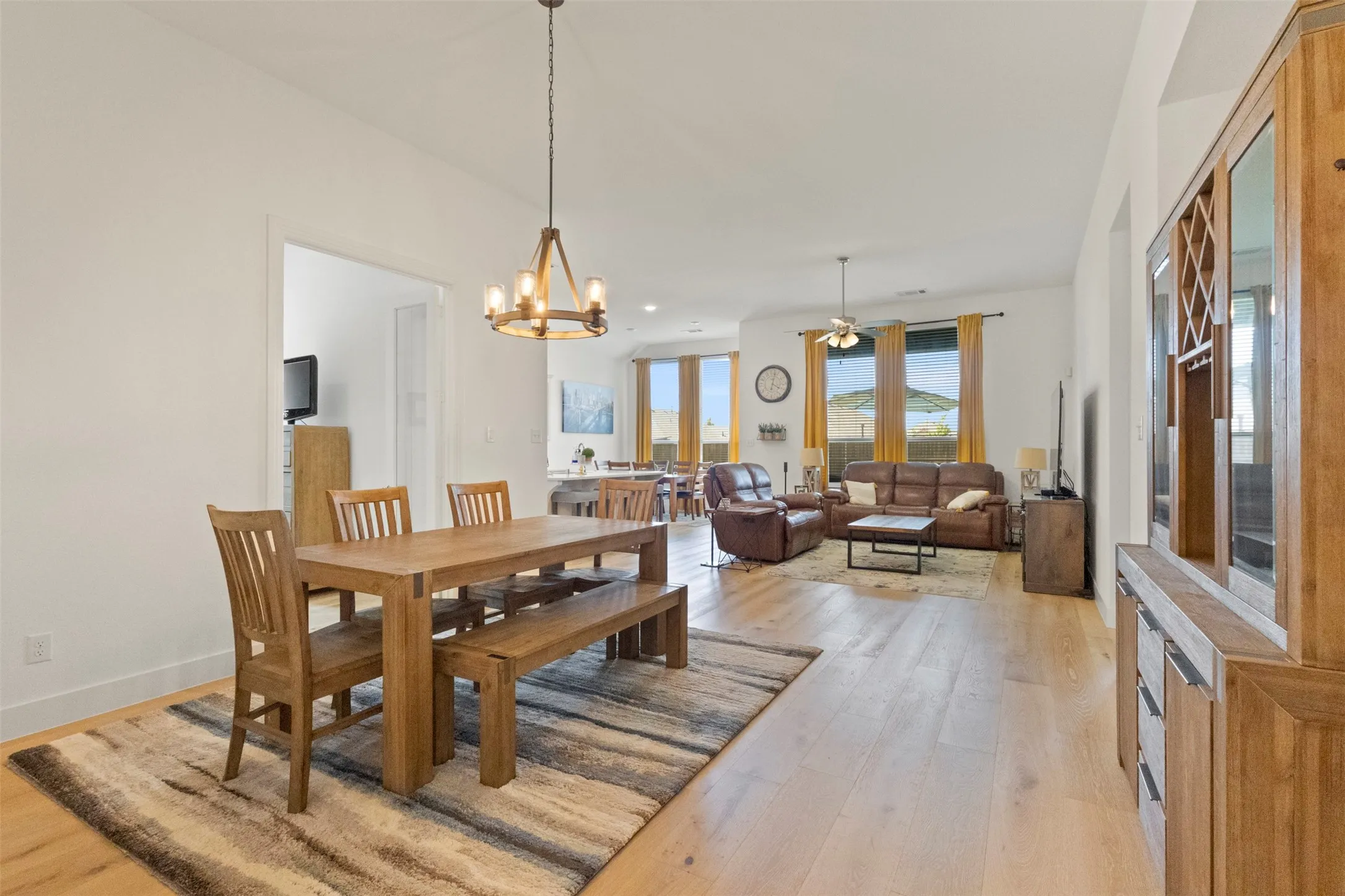 Dining area with light wood-style floors and a chandelier