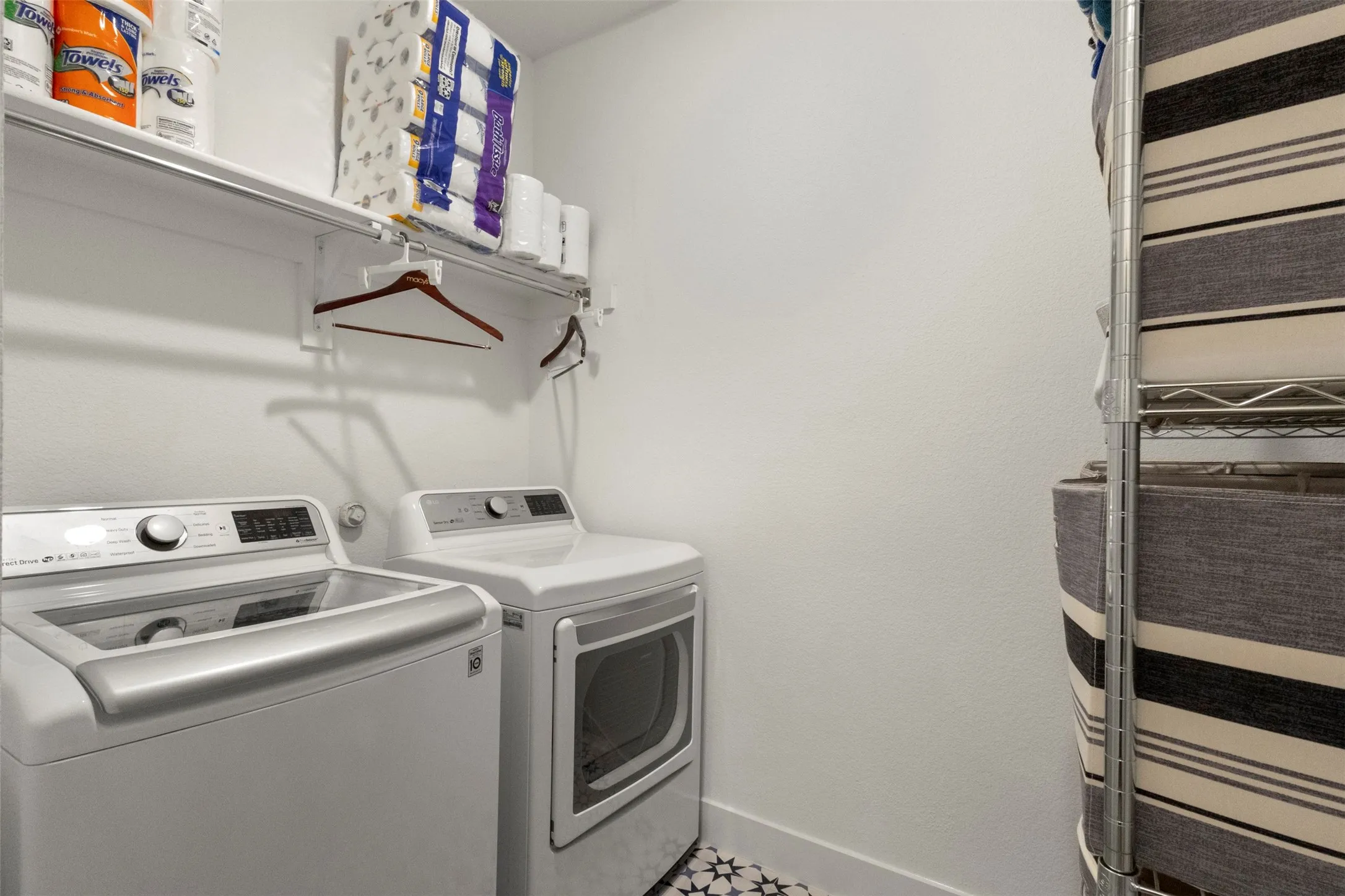 Washroom with separate washer and dryer and baseboards