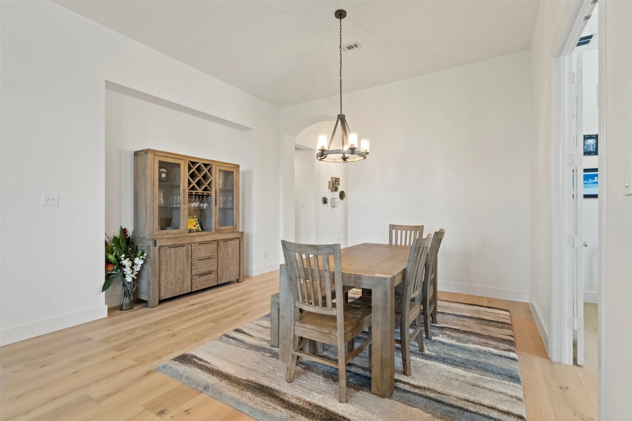 Dining area with a chandelier and light wood-style floors
