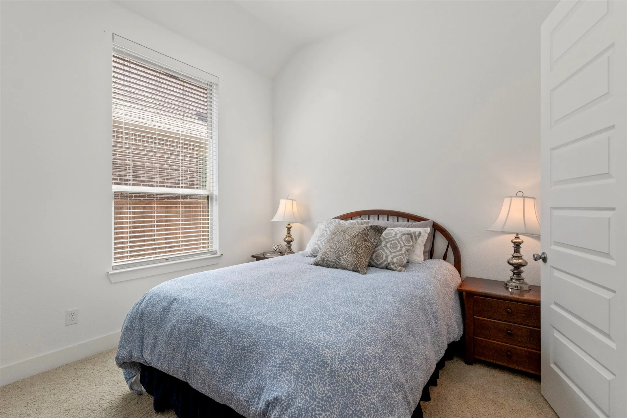 Bedroom featuring carpet and vaulted ceiling