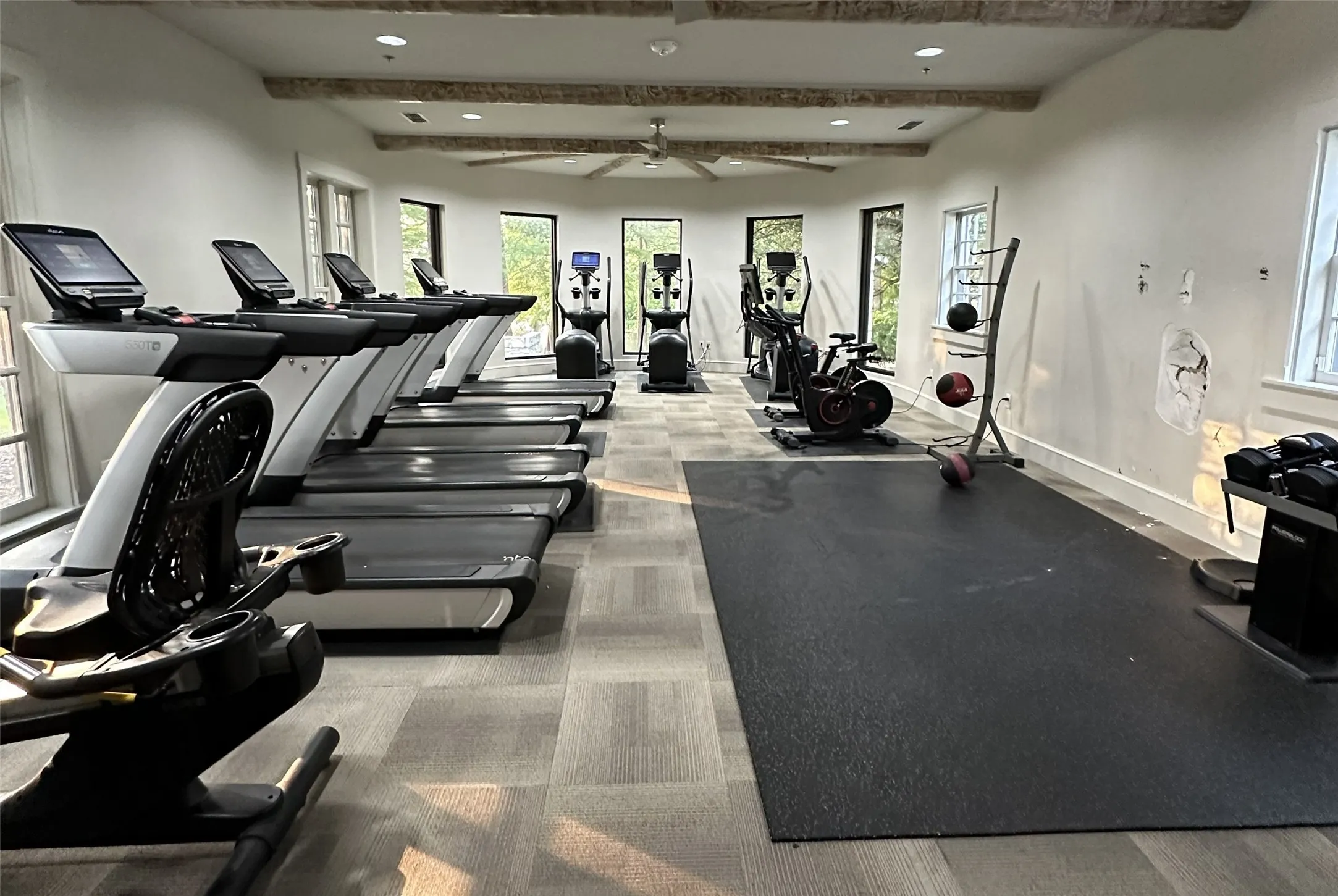 Dedicated fitness area featuring multiple treadmills, elliptical machine, and exercise bike located in the community center *Photo courtesy of Shana Molina*