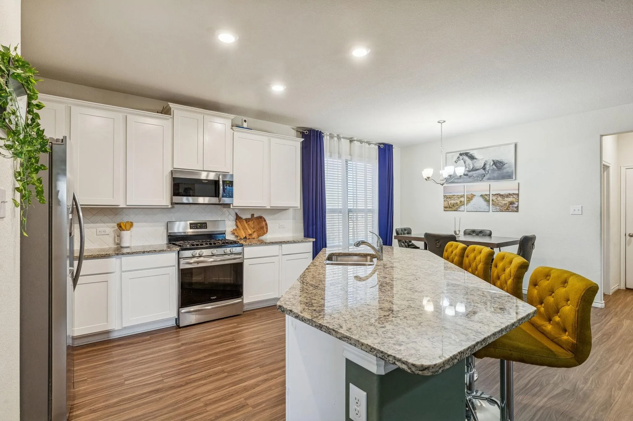 Kitchen island featuring a granite countertop with integrated sink