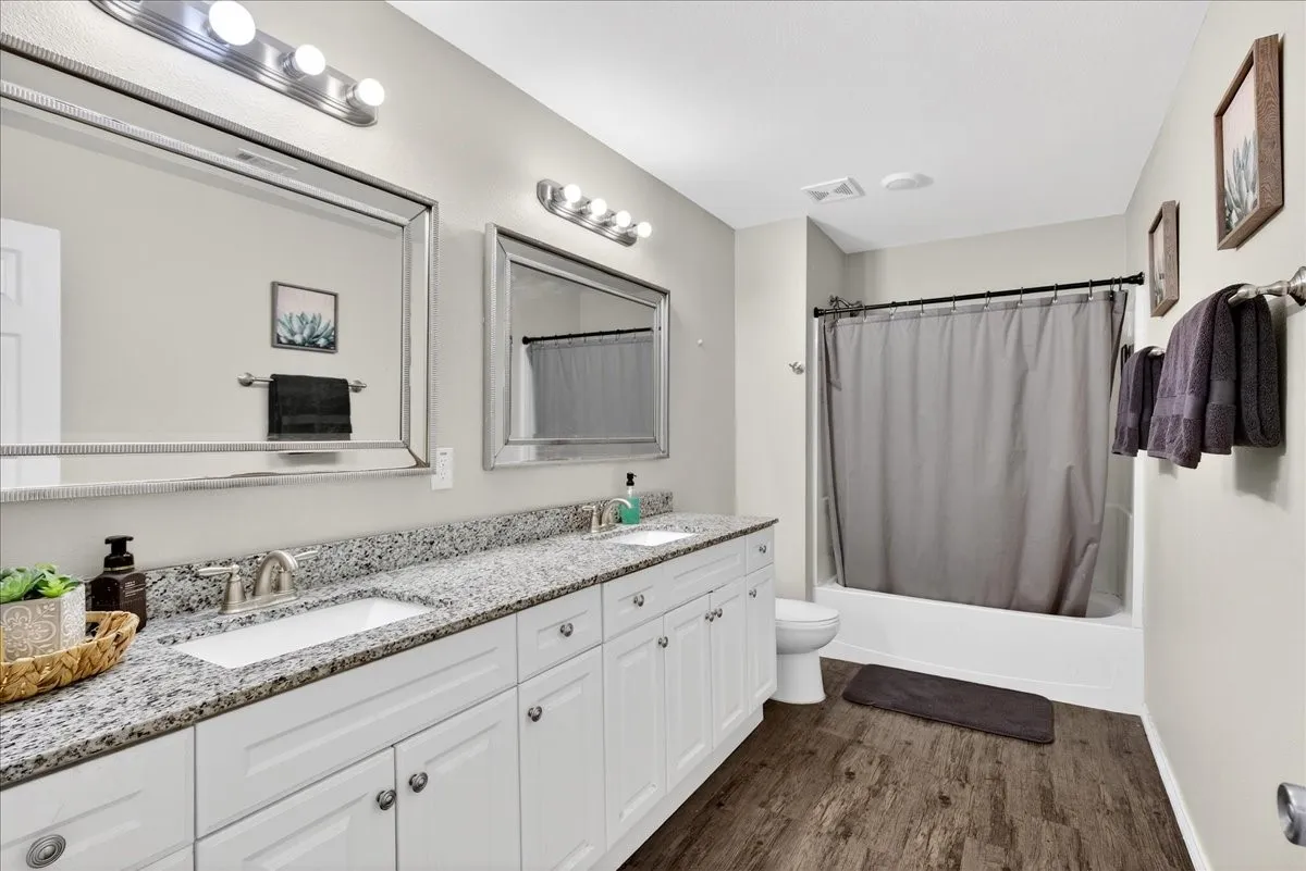 Secondary bathroom with double sinks and granite countertops