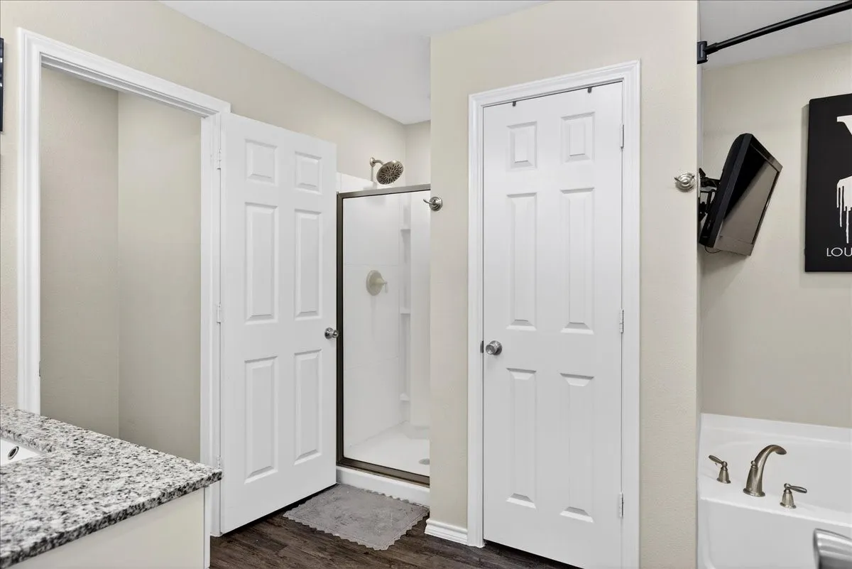 Double vanities, soaking tub, separate shower and 2 walk in closets