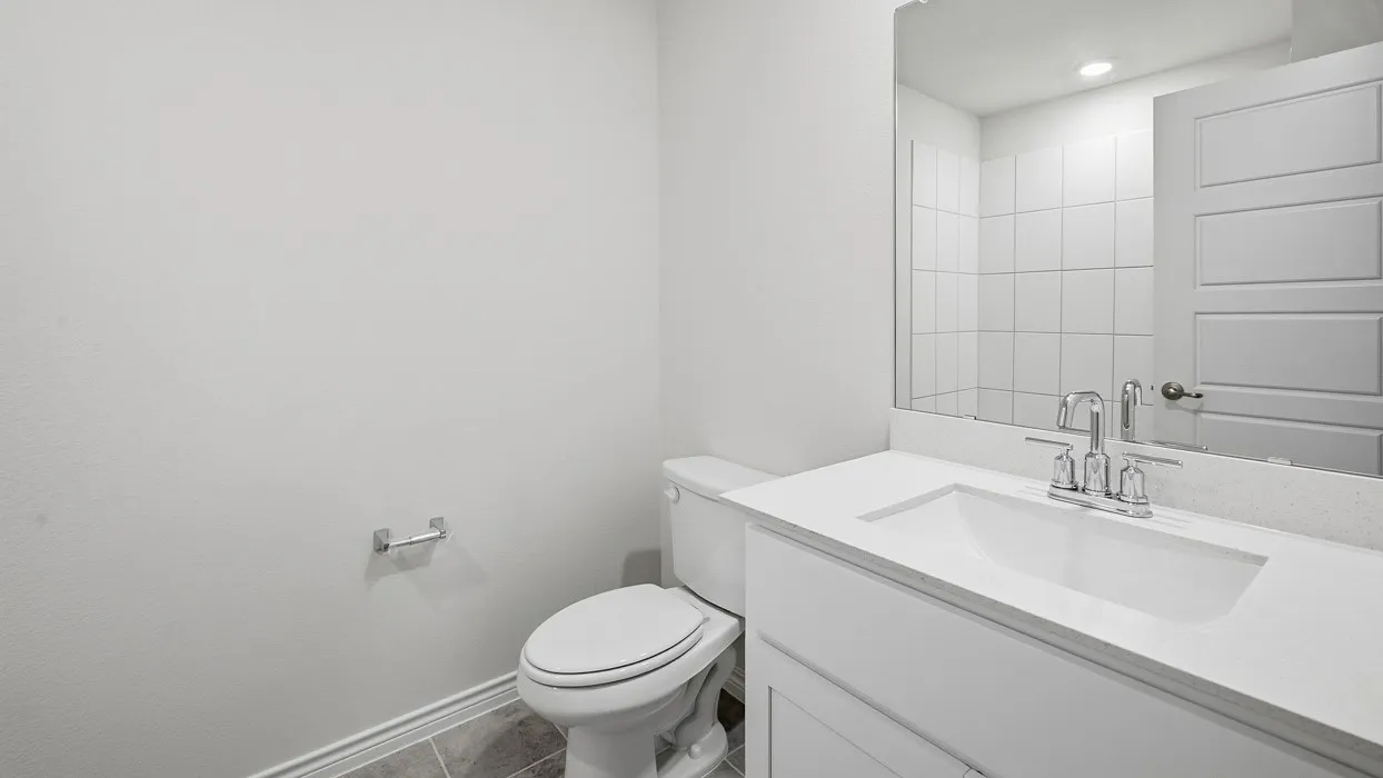 Half bath featuring vanity, tile patterned floors, and recessed lighting