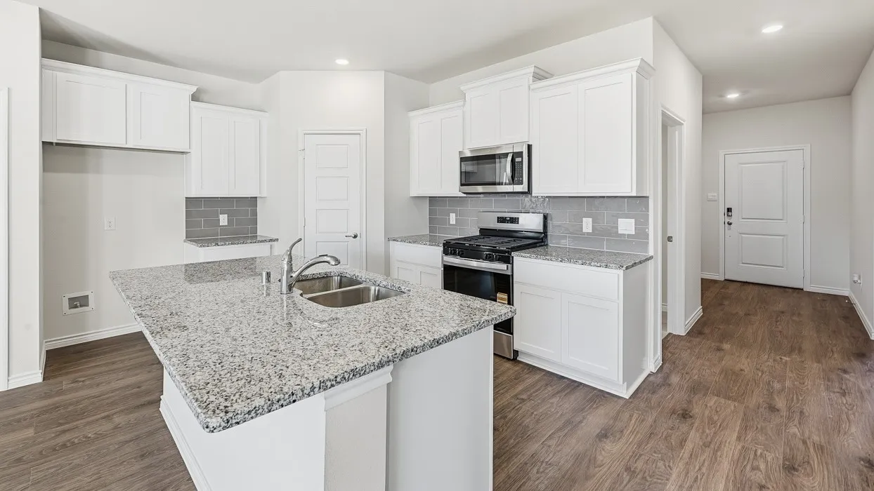 Kitchen with stainless steel appliances, white cabinetry, tasteful backsplash, dark wood finished floors, and recessed lighting