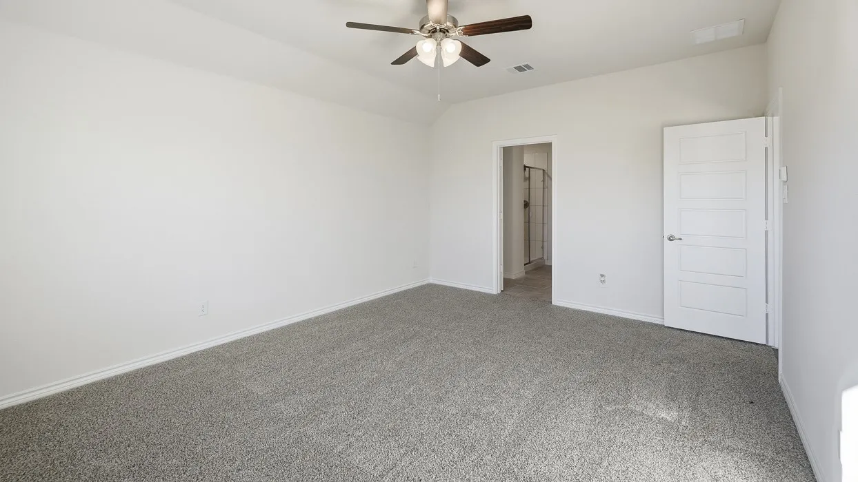 Unfurnished bedroom with carpet floors, ceiling fan, and vaulted ceiling