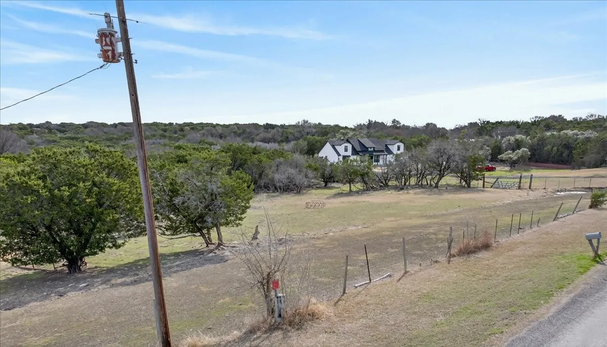 View of asphalt road featuring a view of rural / pastoral area