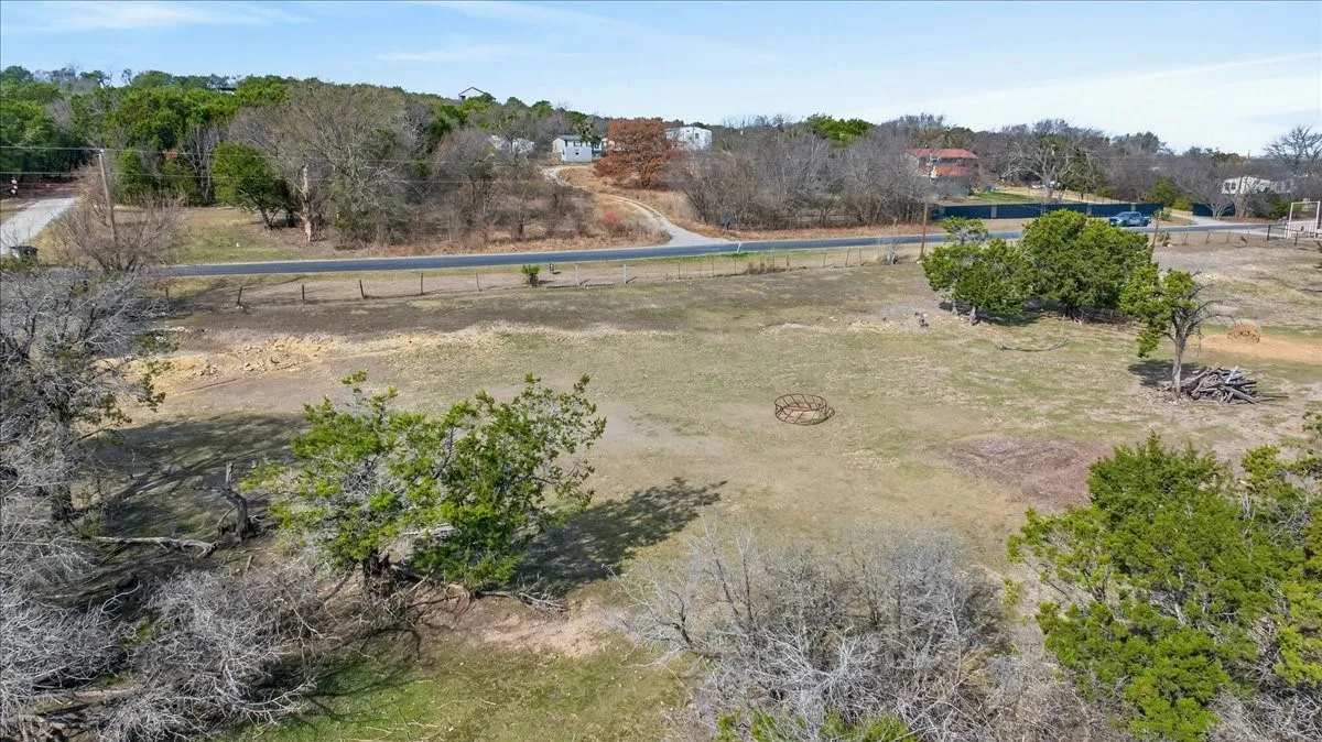 Aerial view of sparsely populated area featuring a tree filled landscape