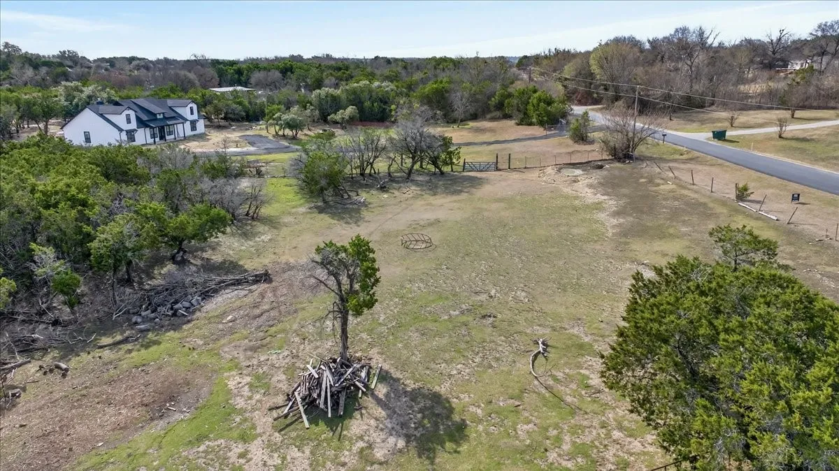 Aerial view of sparsely populated area featuring a tree filled landscape
