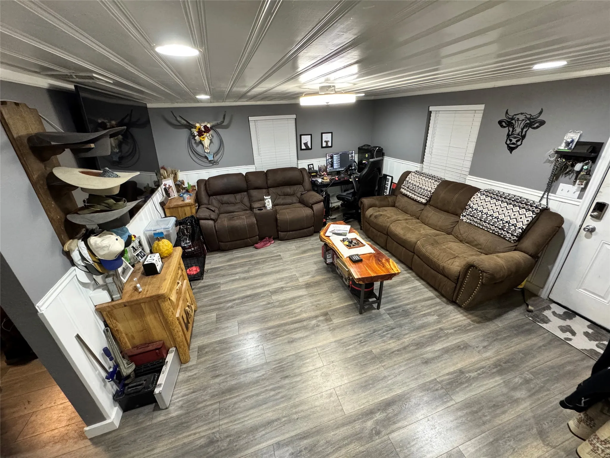 Living room featuring wainscoting, wood- style finished floors, and ship lap ceiling