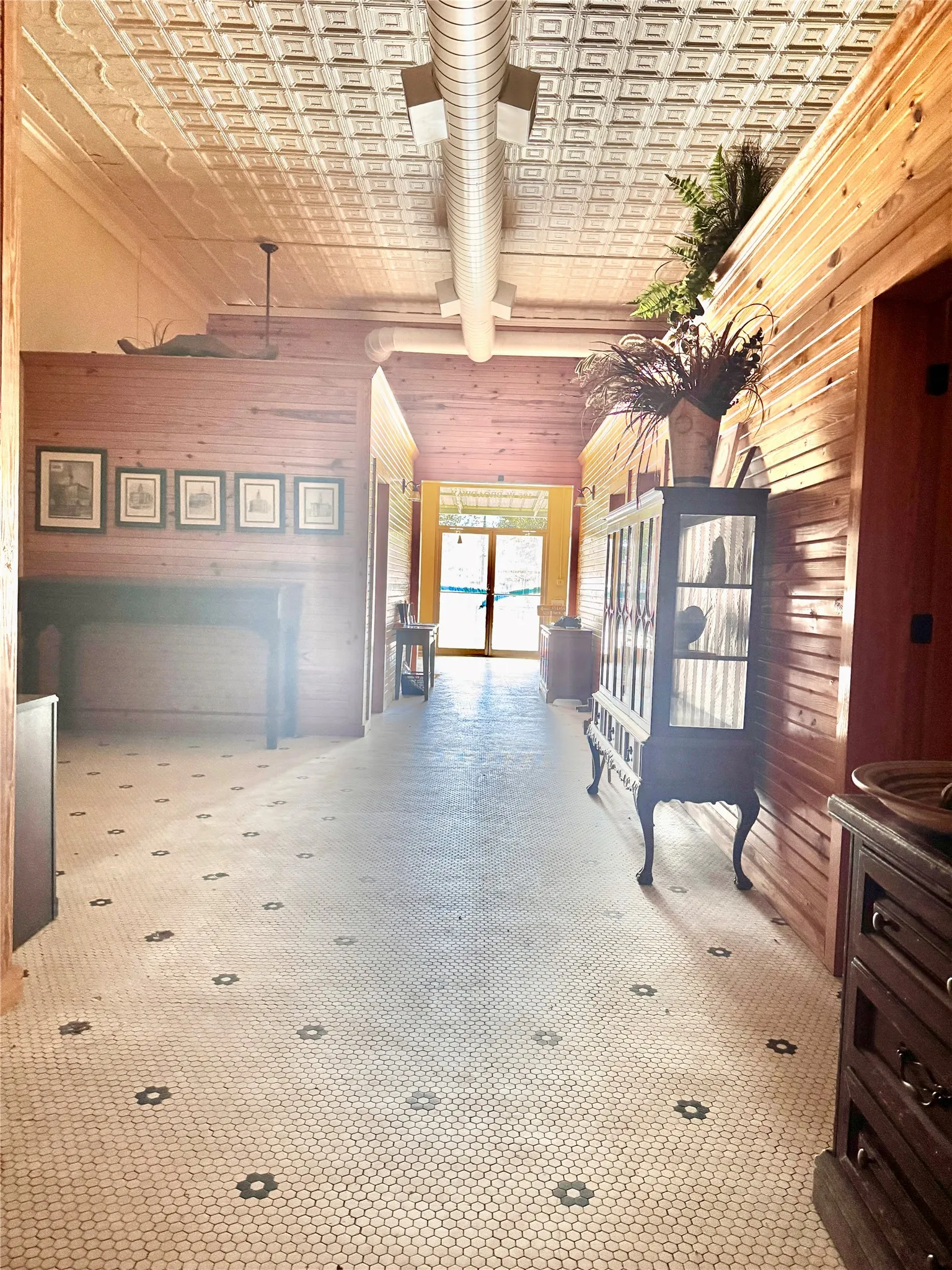 At the end of the hall, looking back at the front of the front door.