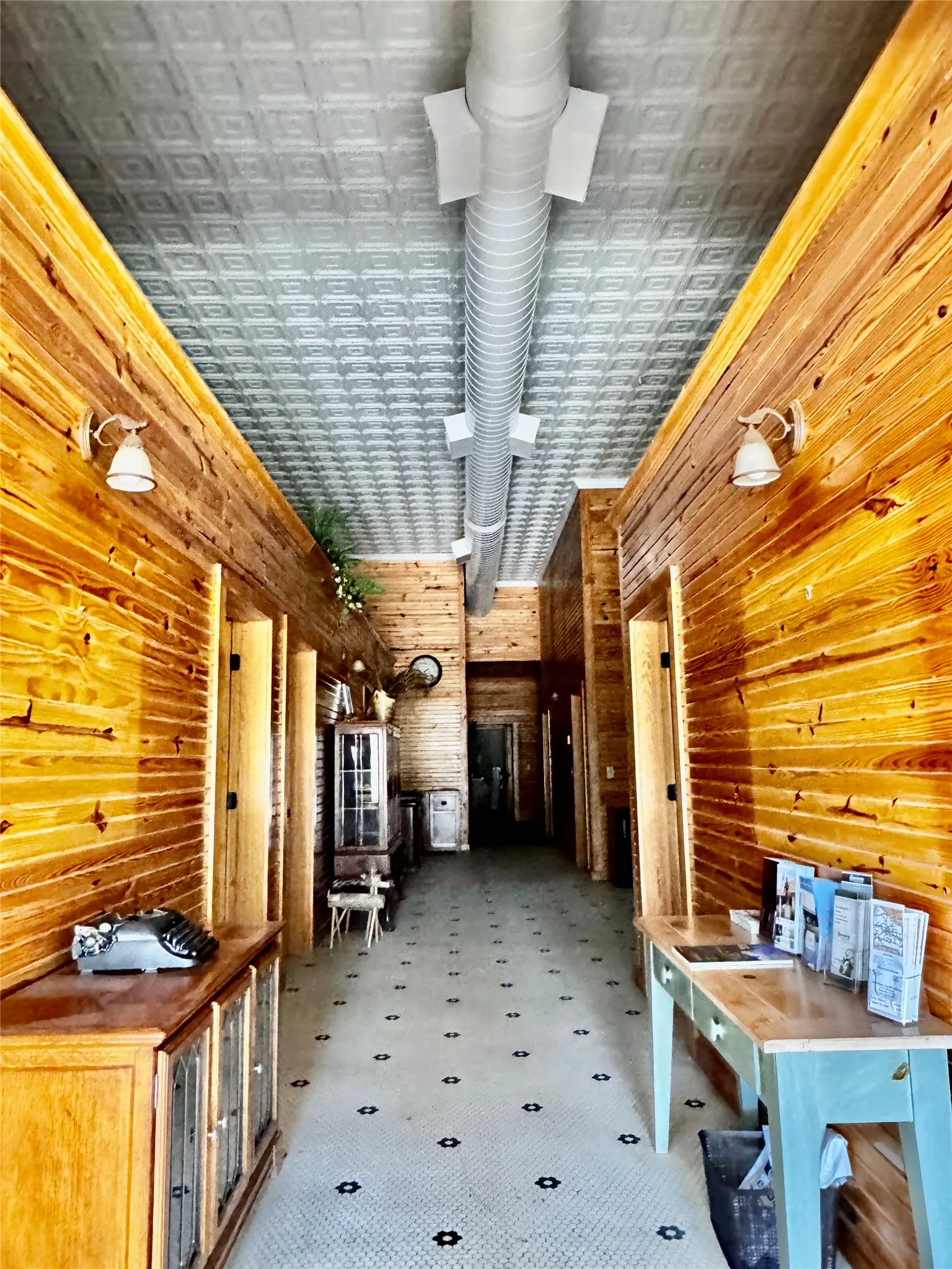 Long hall that has 5 updated private offices on each side.  A total of 5 office and a reception area on the bottom floor.