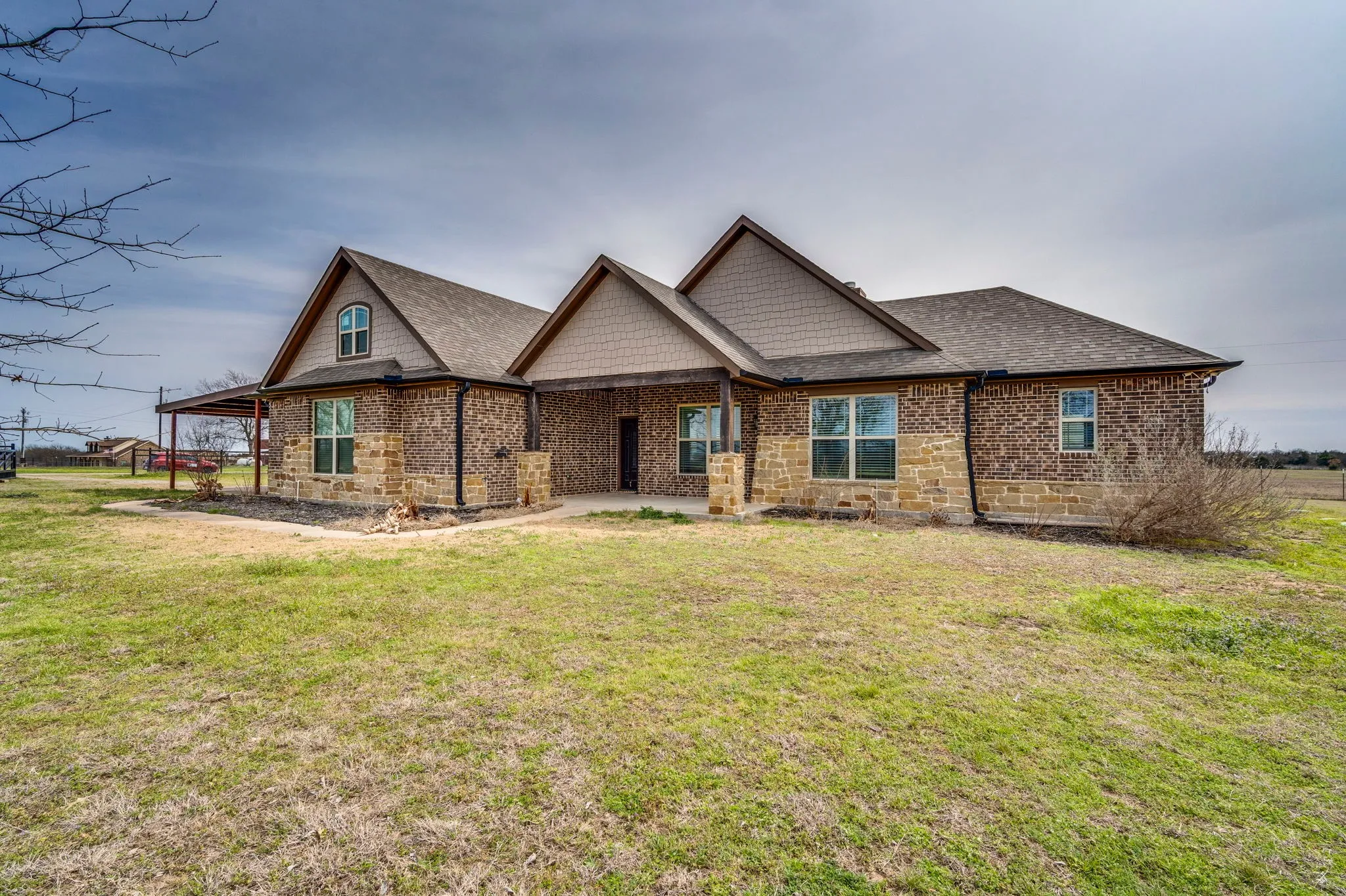 Craftsman inspired home with a front yard, brick siding, and a shingled roof