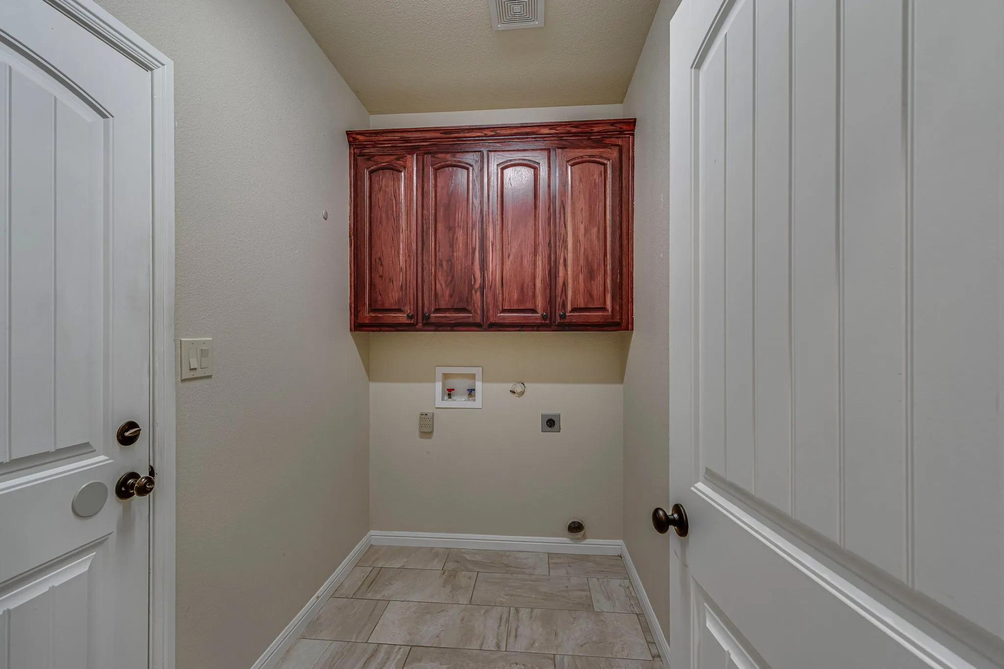 Laundry area featuring cabinet space, gas dryer hookup, washer hookup, and hookup for an electric dryer