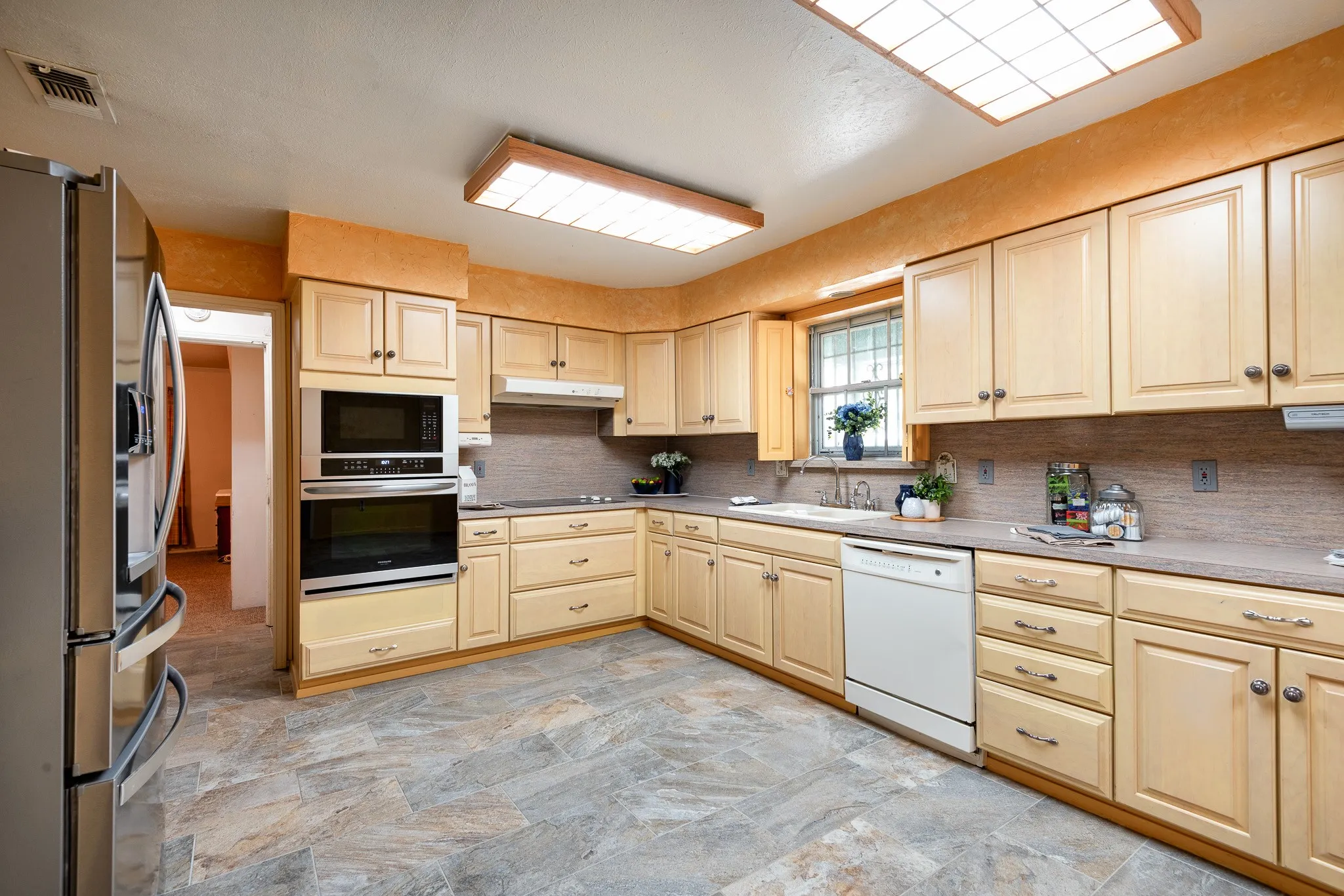 Oversized kitchen with abundant cabinetry & counter space