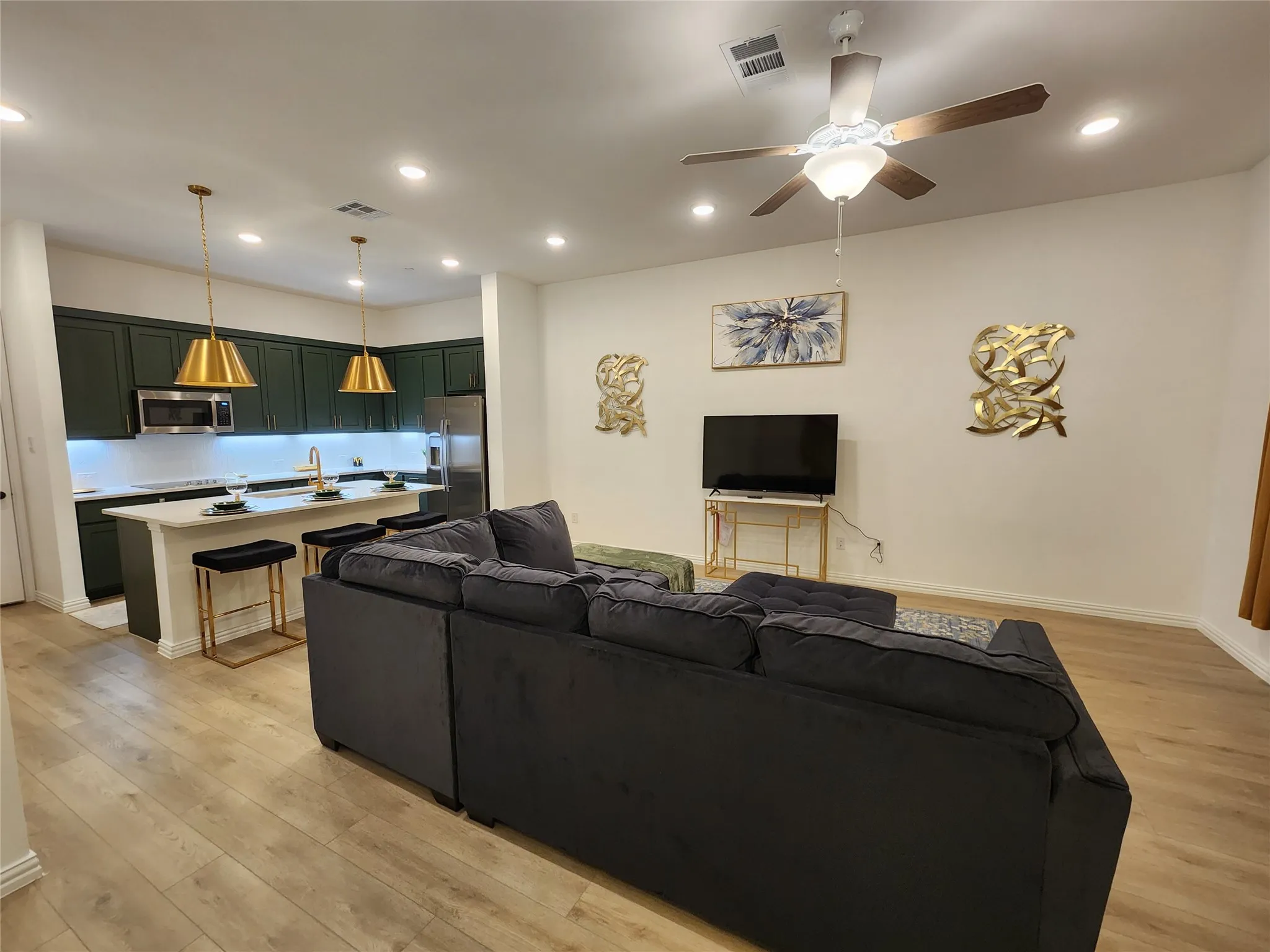 Living area featuring light wood-style flooring, recessed lighting, and ceiling fan
