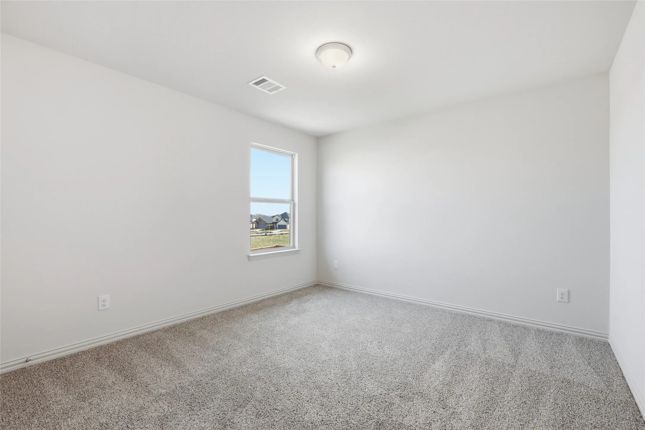 Neutral white walls complement light gray carpet flooring