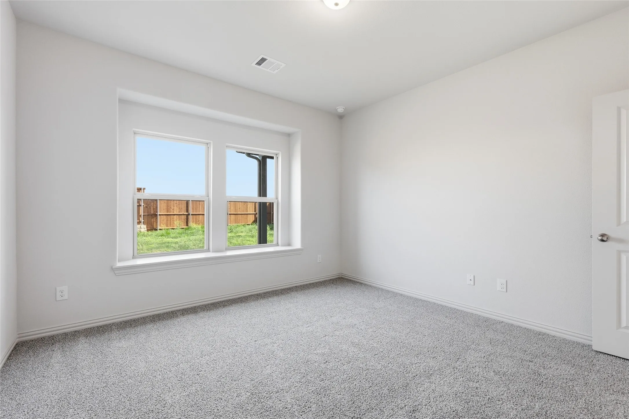 Neutral white walls paired with light gray carpet flooring
