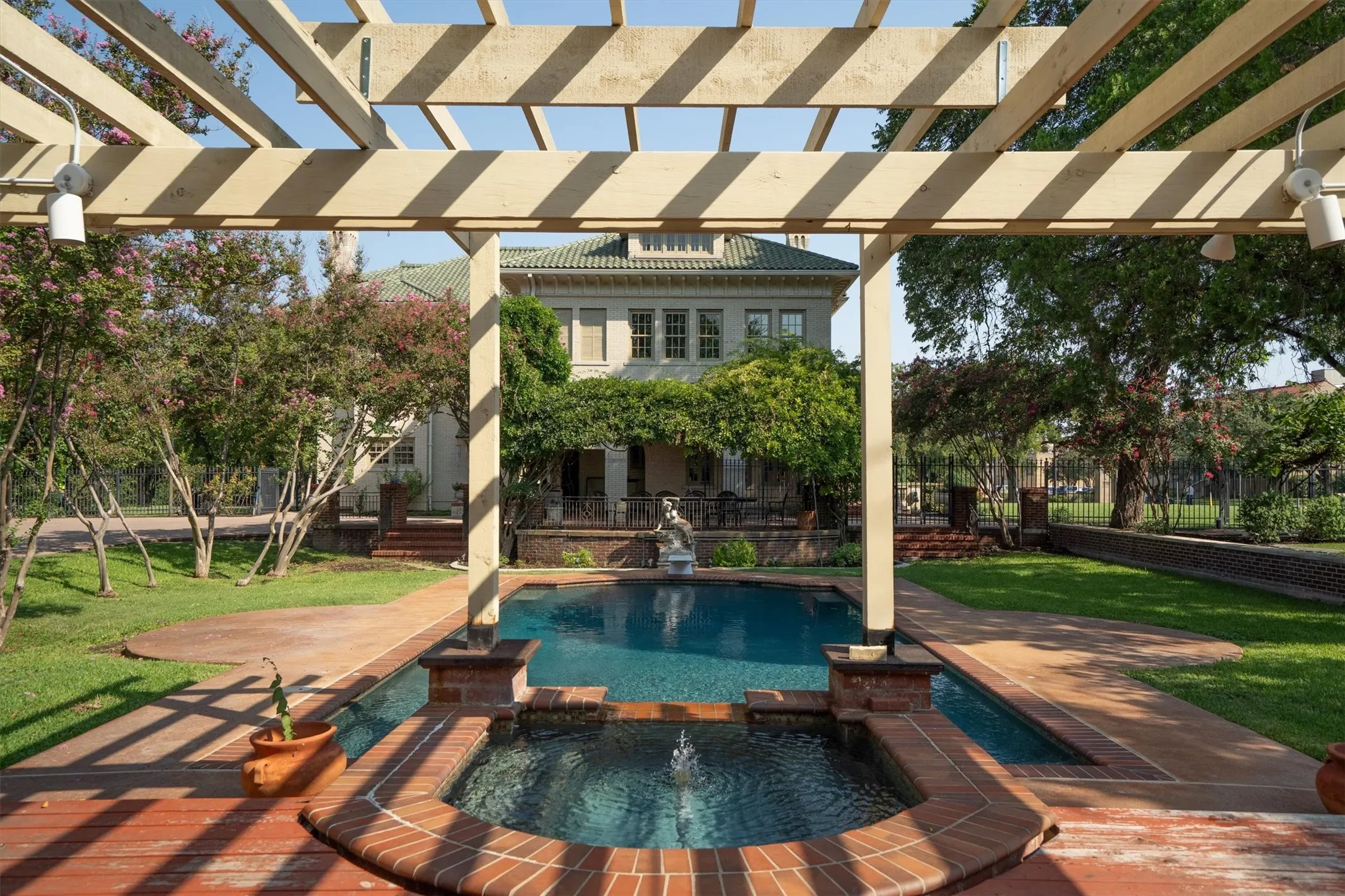 The backyard oasis features a sparkling pool with a connected hot tub, a spacious patio area, and a
charming pergola, creating the perfect setting for relaxation and outdoor entertaining.