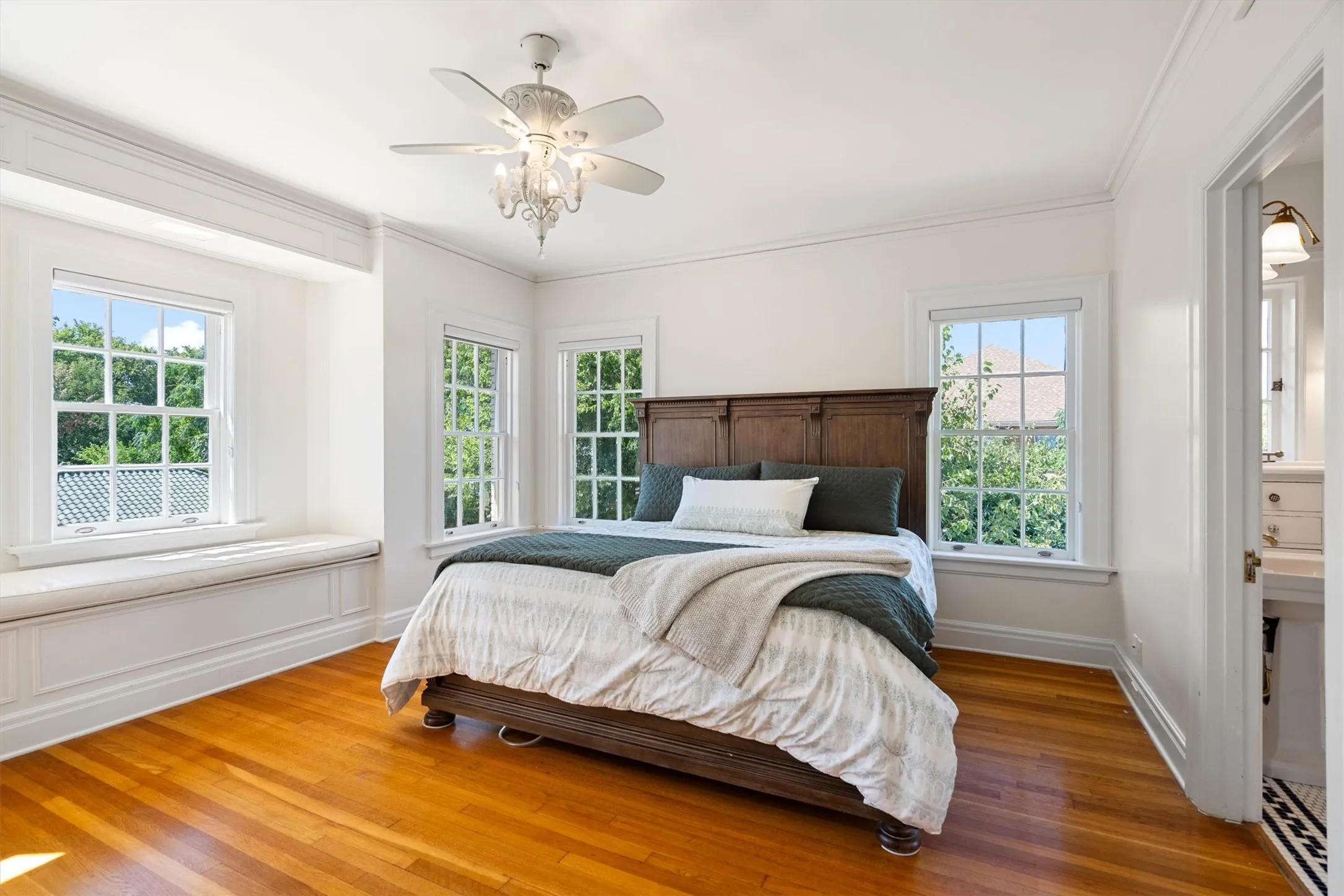 This inviting bedroom offers a private en suite bath
and a beautiful window seat, creating a cozy nook
bathed in natural light—perfect for reading or relaxing in comfort.