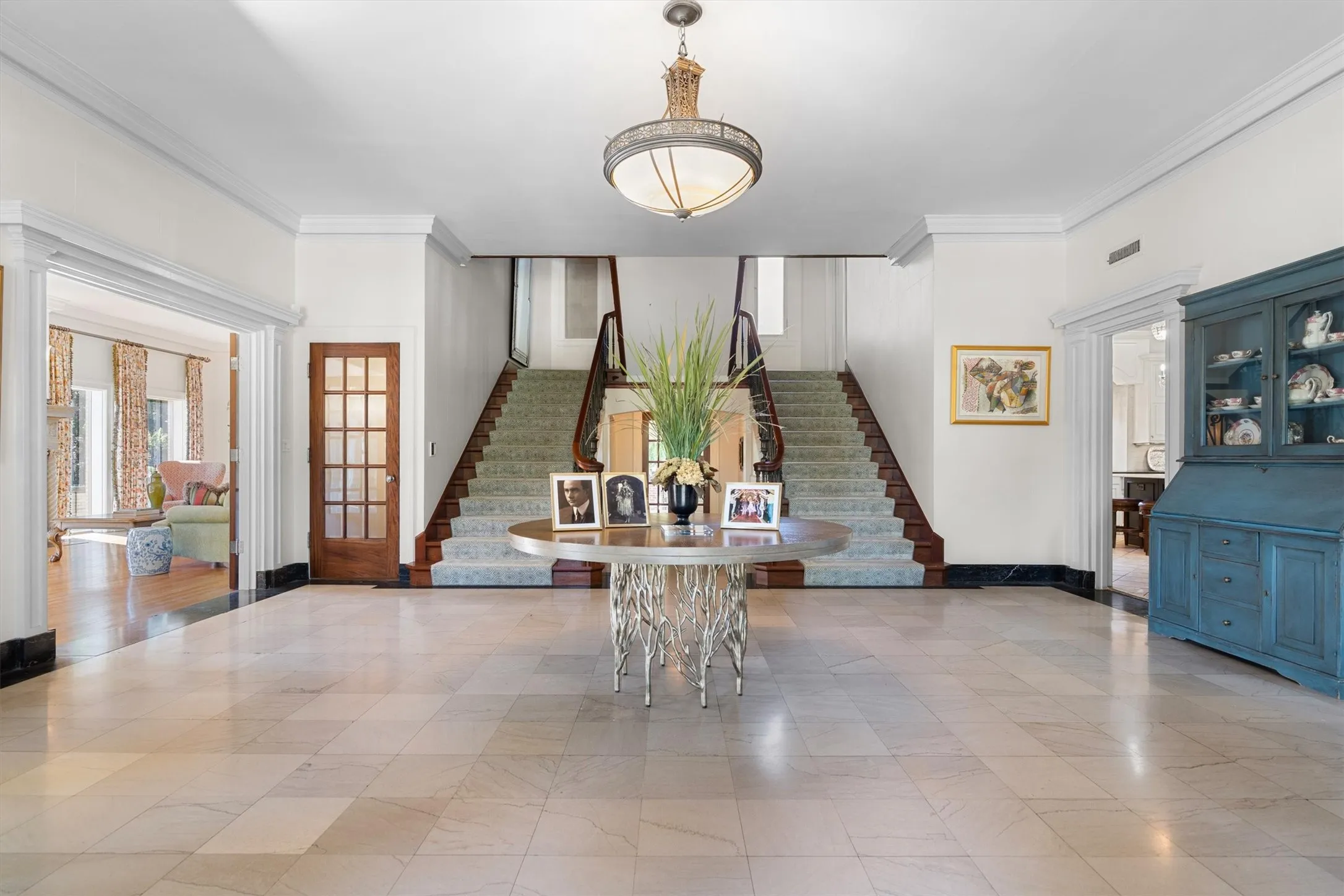 Greet your guests in this impressive entryway
showcasing a sweeping dual staircase, elegant
marble floors, and abundant natural light.