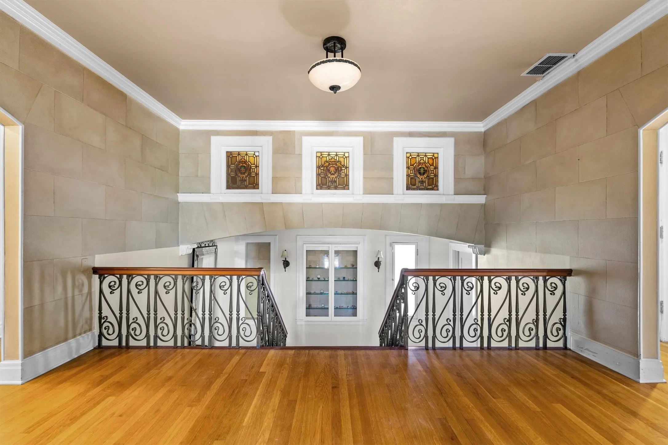 This home showcases a striking, one-of-a-kind stained glass feature, beautifully illuminated to cast colorful, artistic light throughout the space, adding both character and a touch of elegance.