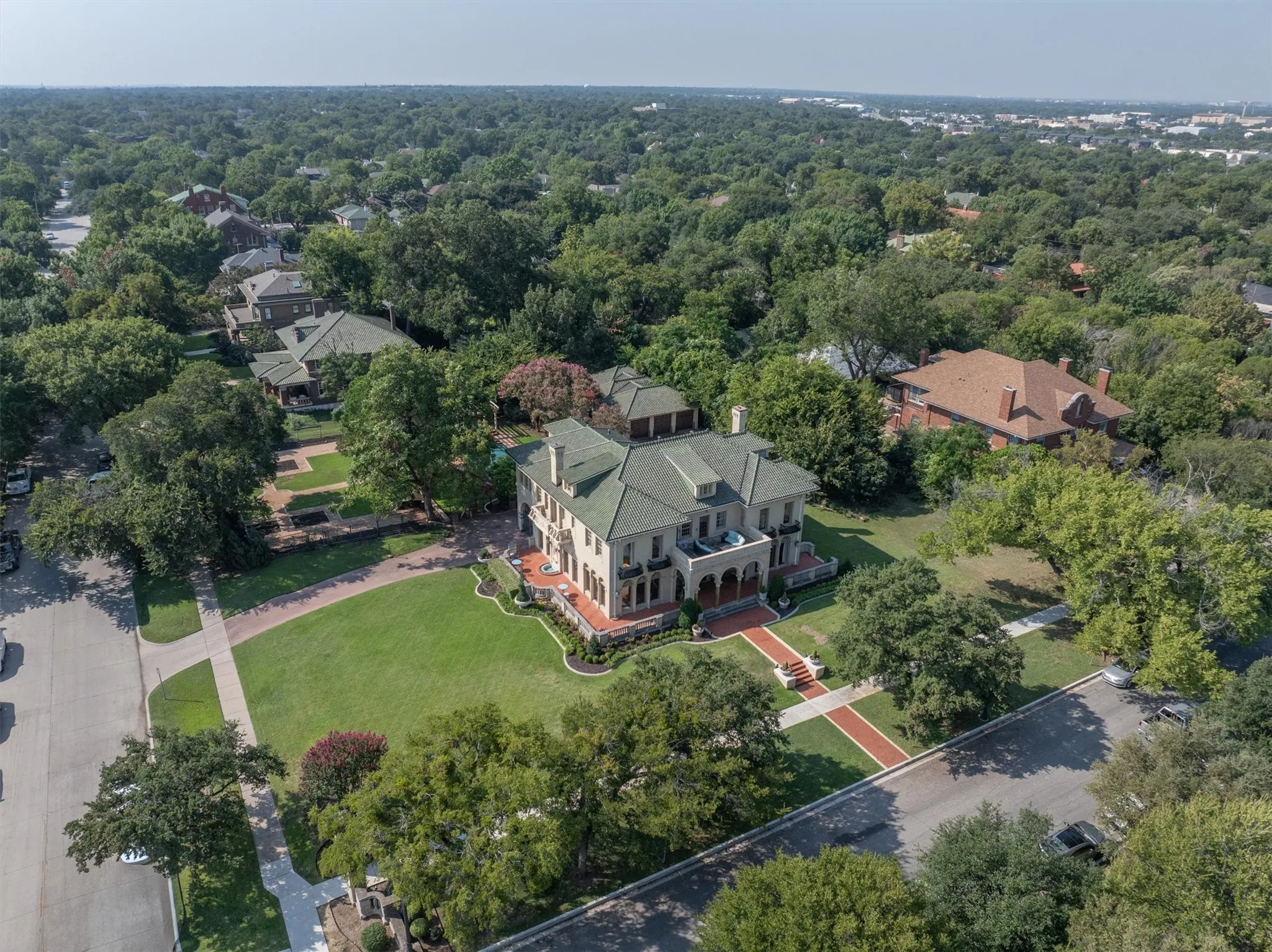 This aerial view captures the historic charm of the property while also showcasing the nearby suburban area, blending timeless elegance with
modern convenience.