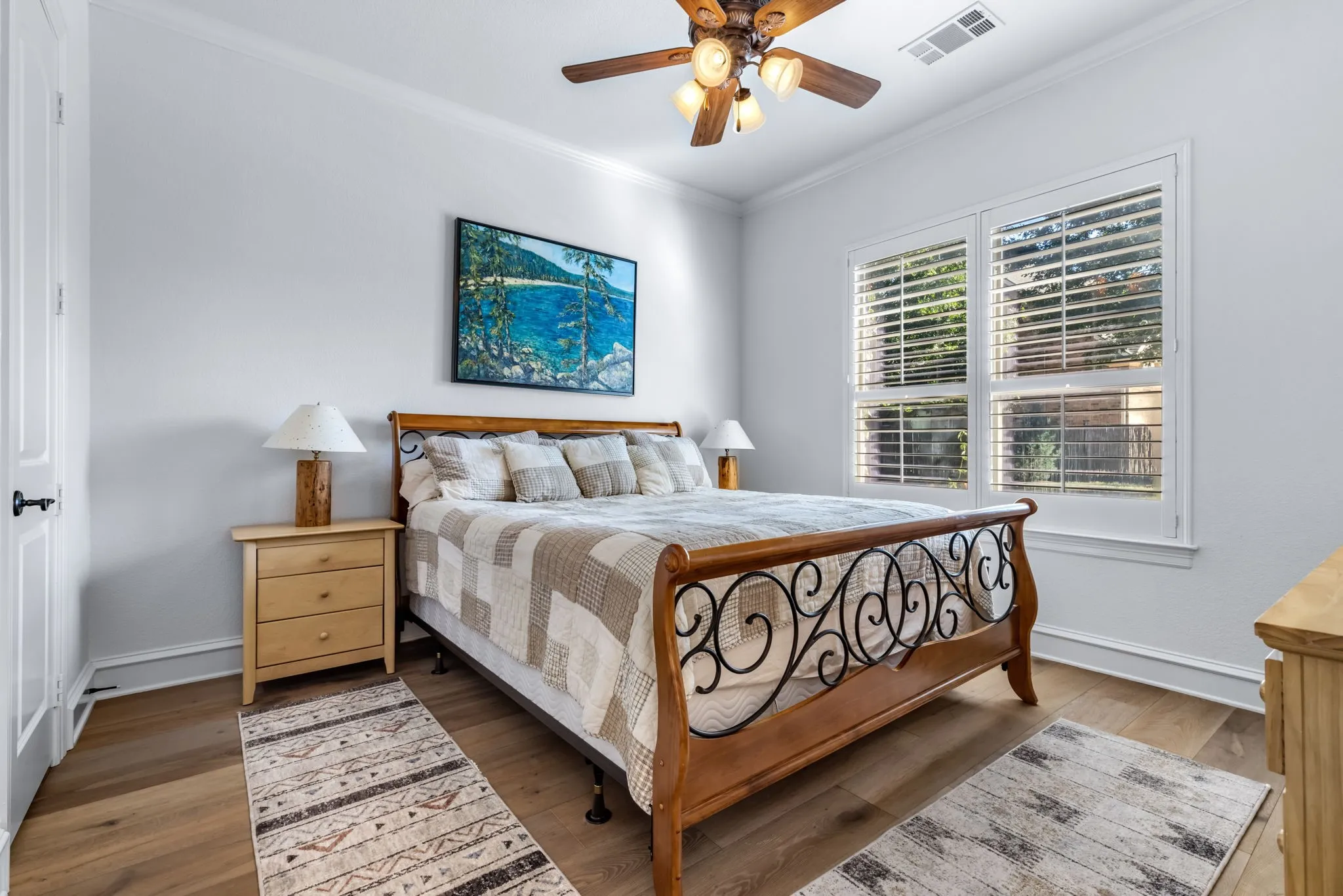 Bedroom featuring crown molding, a ceiling fan, and wood finished floors