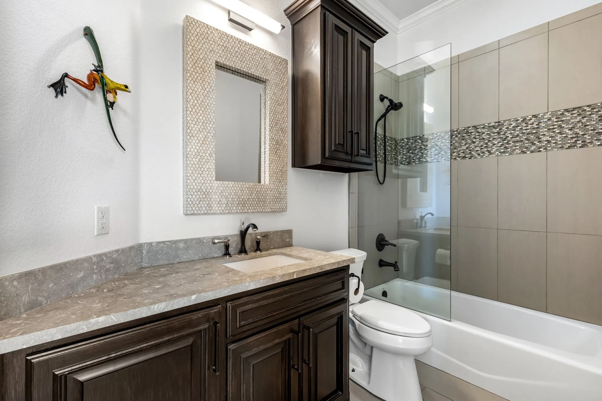 Bathroom featuring bathtub / shower combination, vanity, and ornamental molding