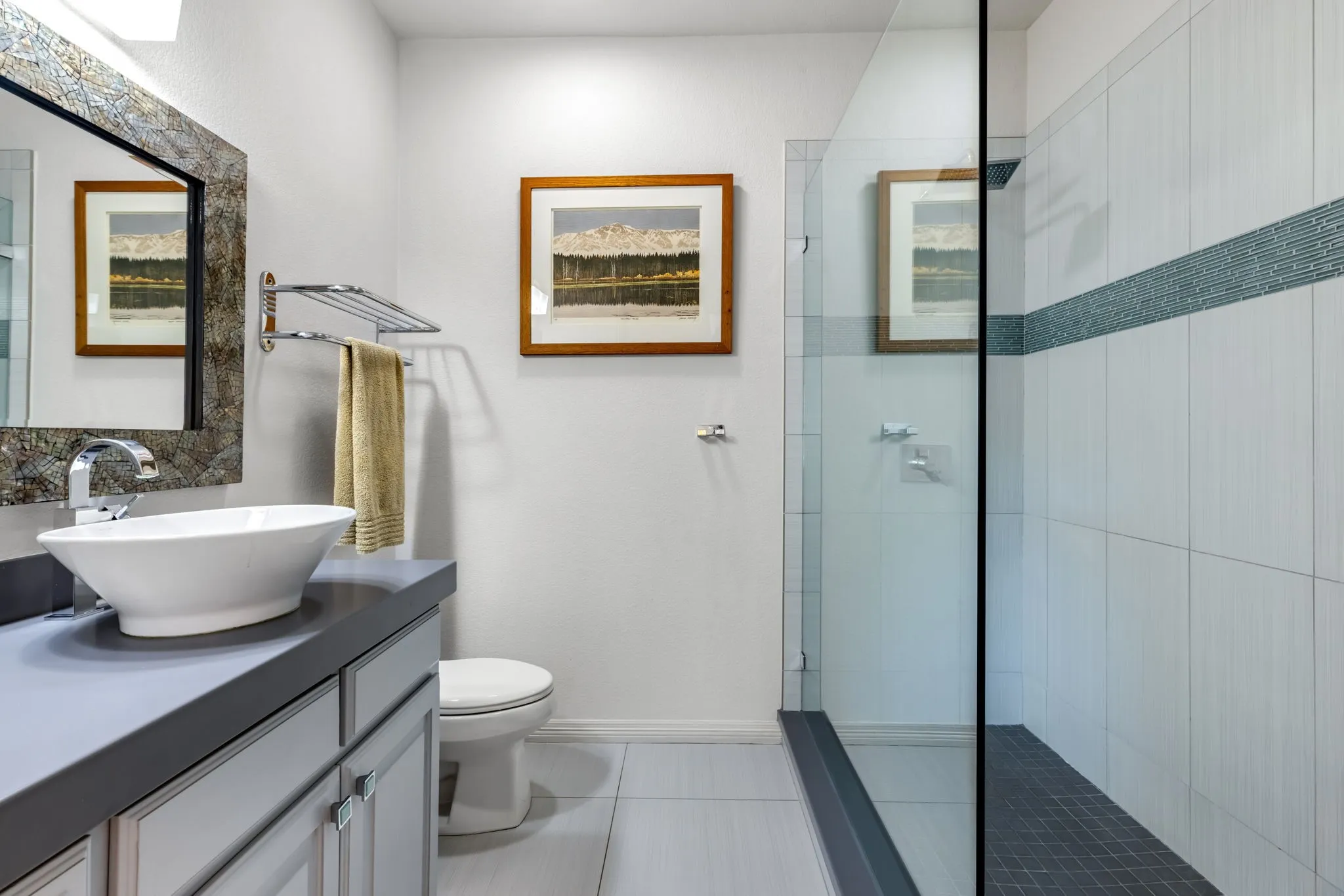 Full bath with a walk in shower, vanity, and light tile patterned flooring