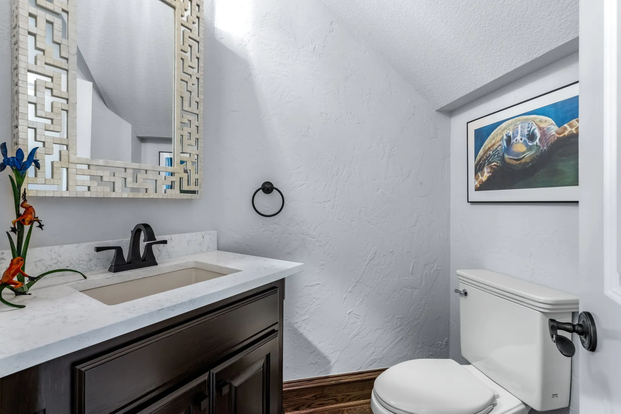 Bathroom featuring a textured wall, a textured ceiling, and vanity
