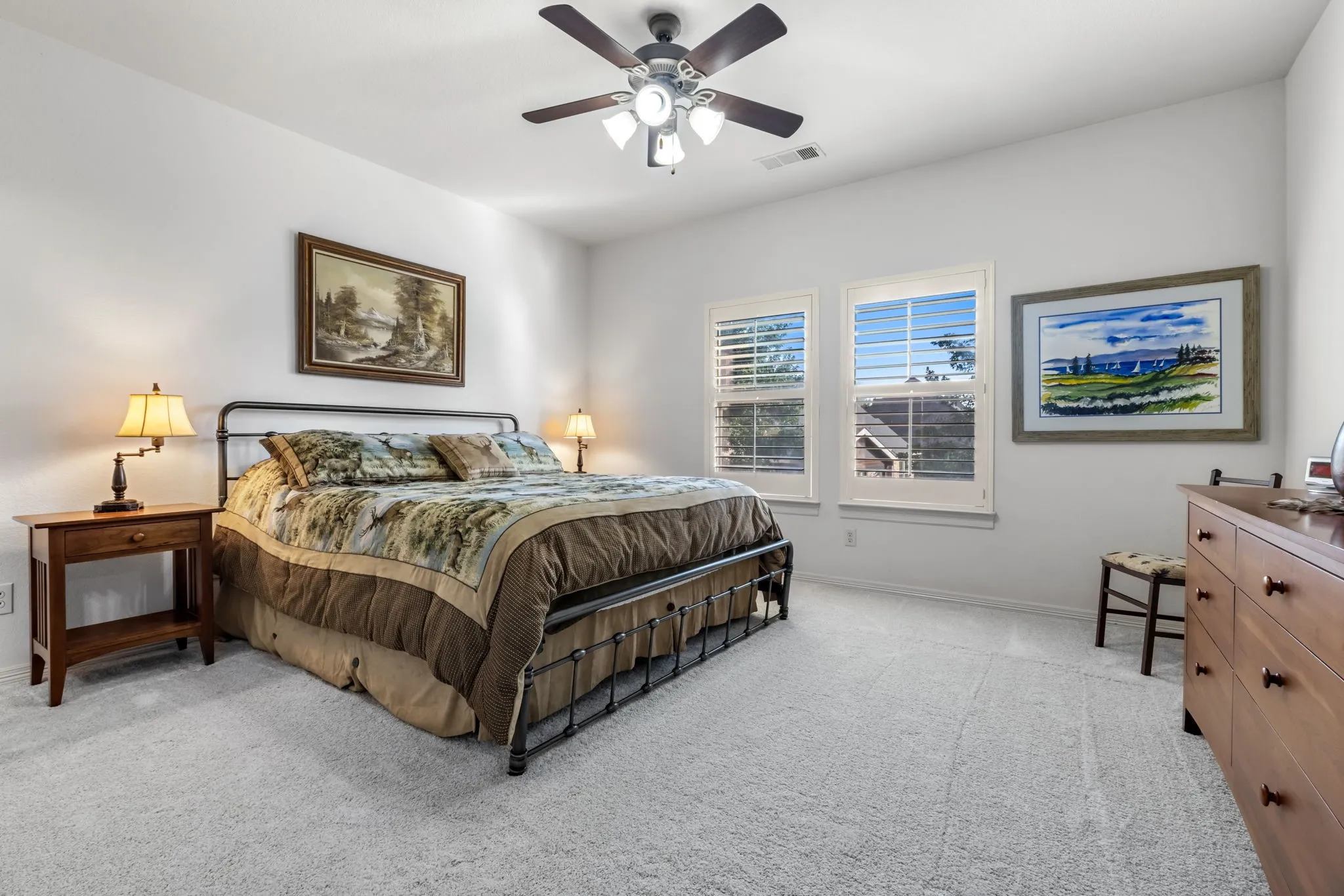 Bedroom featuring light colored carpet and a ceiling fan