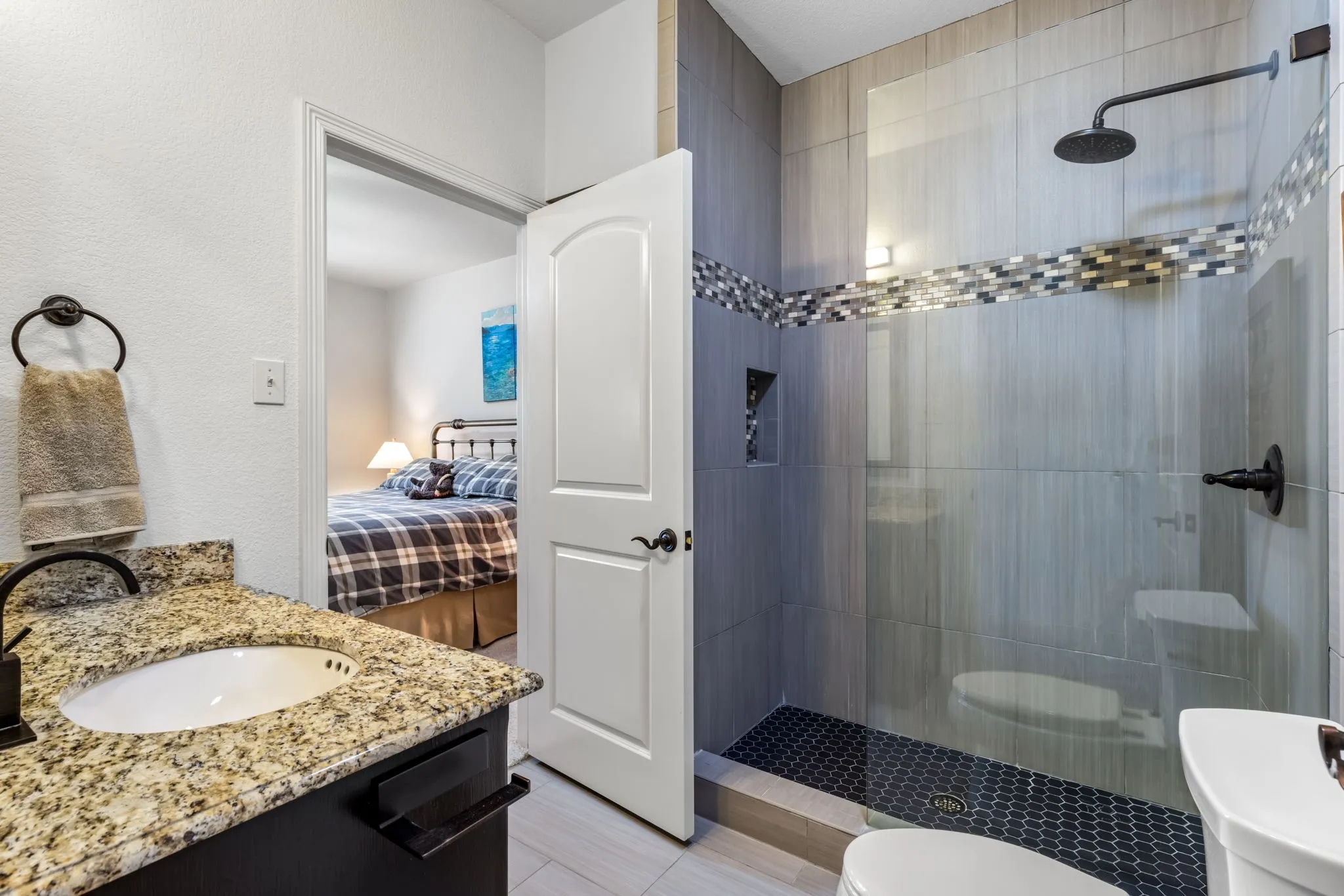 Ensuite bathroom featuring a walk in shower and vanity