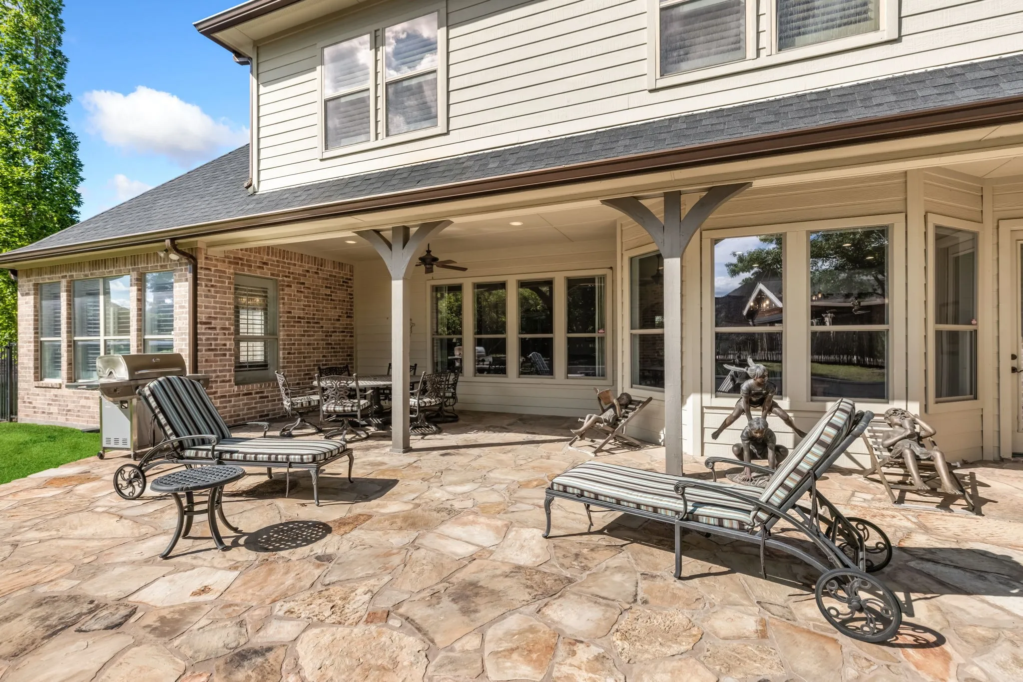 View of patio featuring a grill and ceiling fan