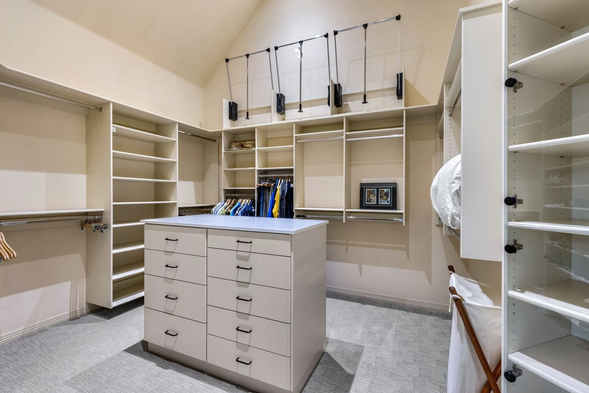 Walk in closet featuring light carpet and vaulted ceiling