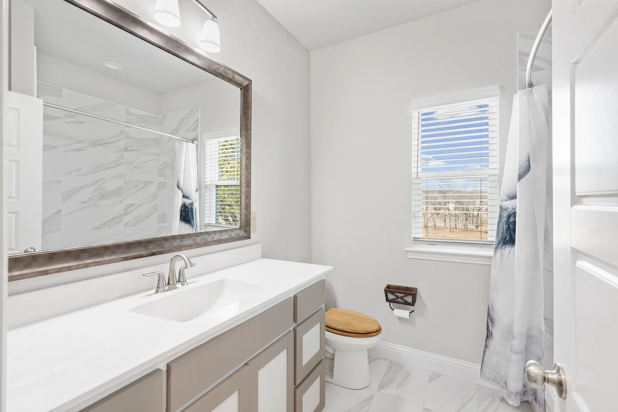 Secondary bathroom has built in storage.