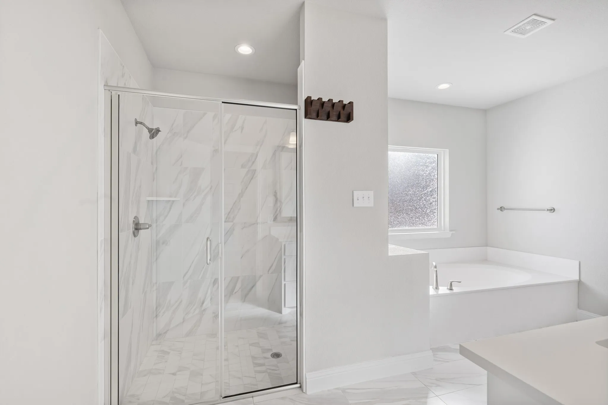 Primary bathroom features a separate shower and tub.