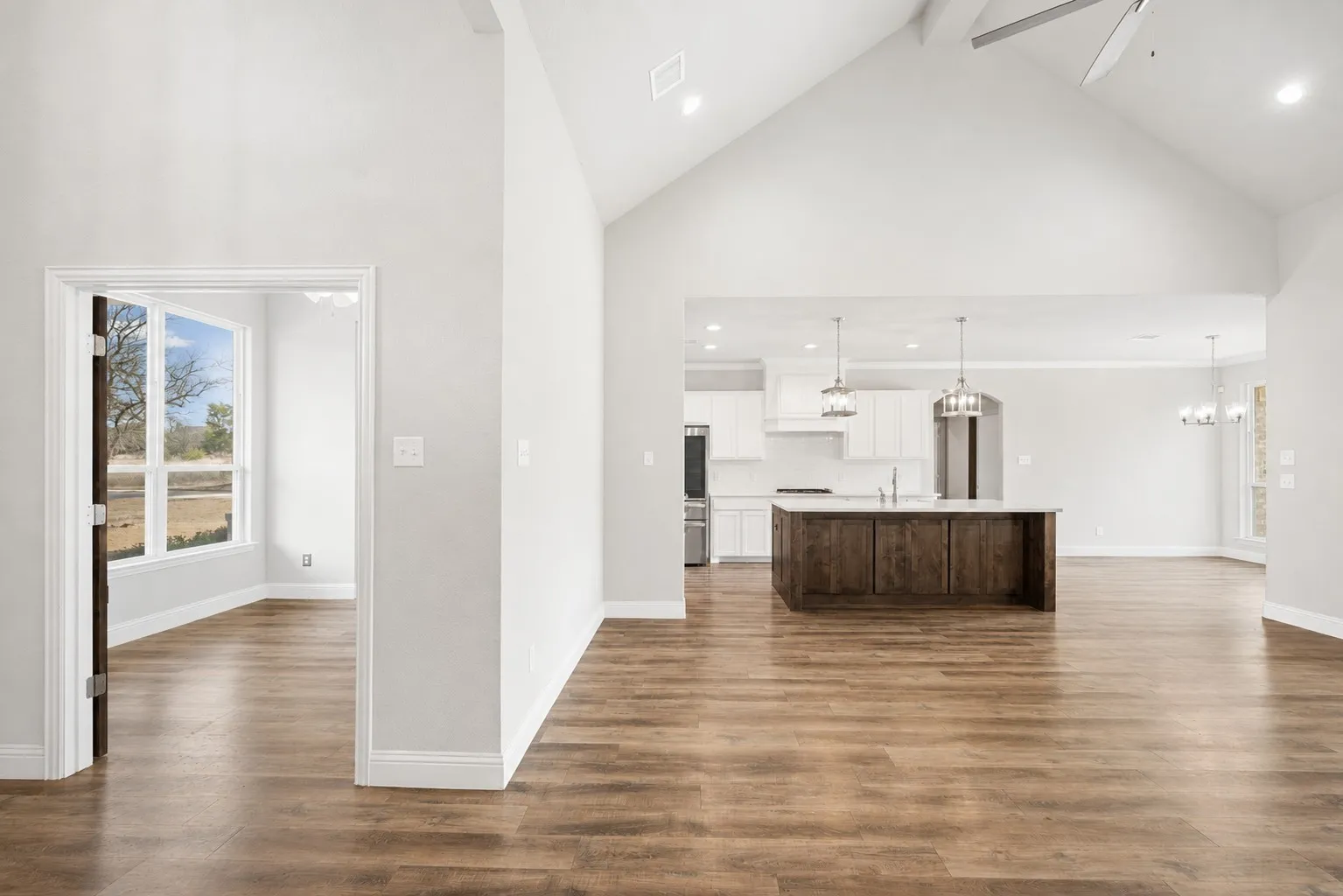 A view of the living room, kitchen and office