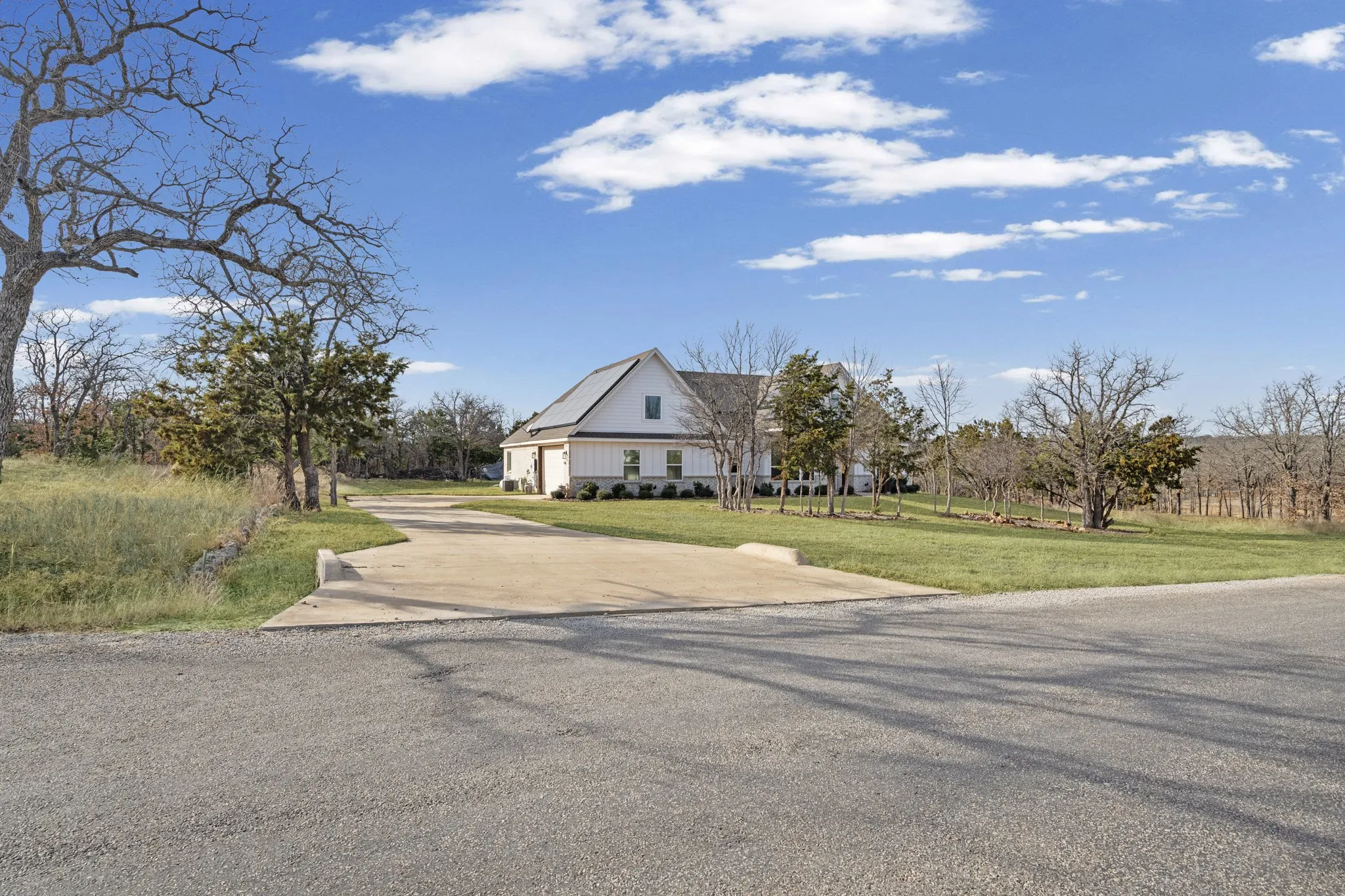 Home offers a landscaped lot including trees.