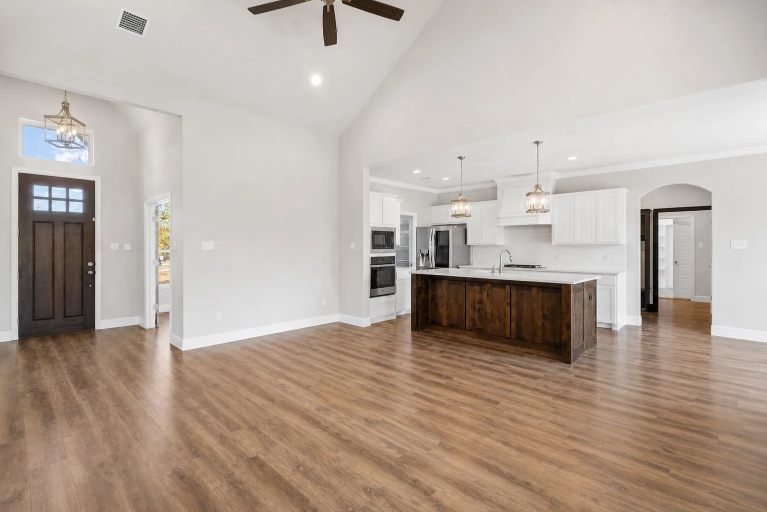 Open floorplan concept with entry leading into living and kitchen and dining area.