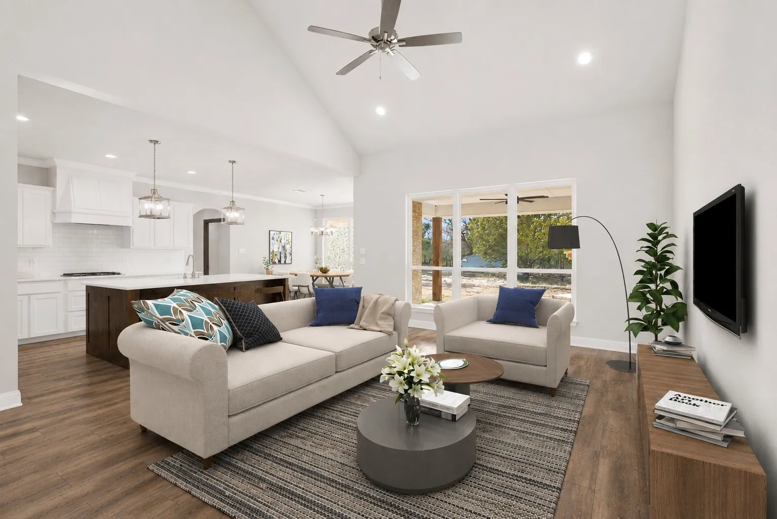 Living room features a vaulted ceiling and large windows, creating an open and welcoming space.