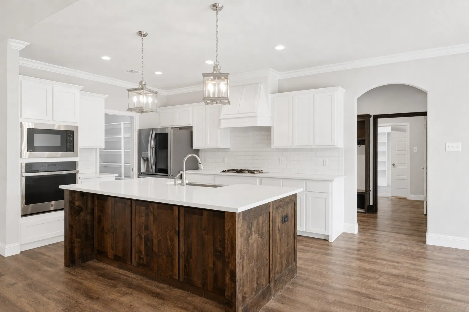 Spacious kitchen features stainless steel appliances and a gas cooktop.