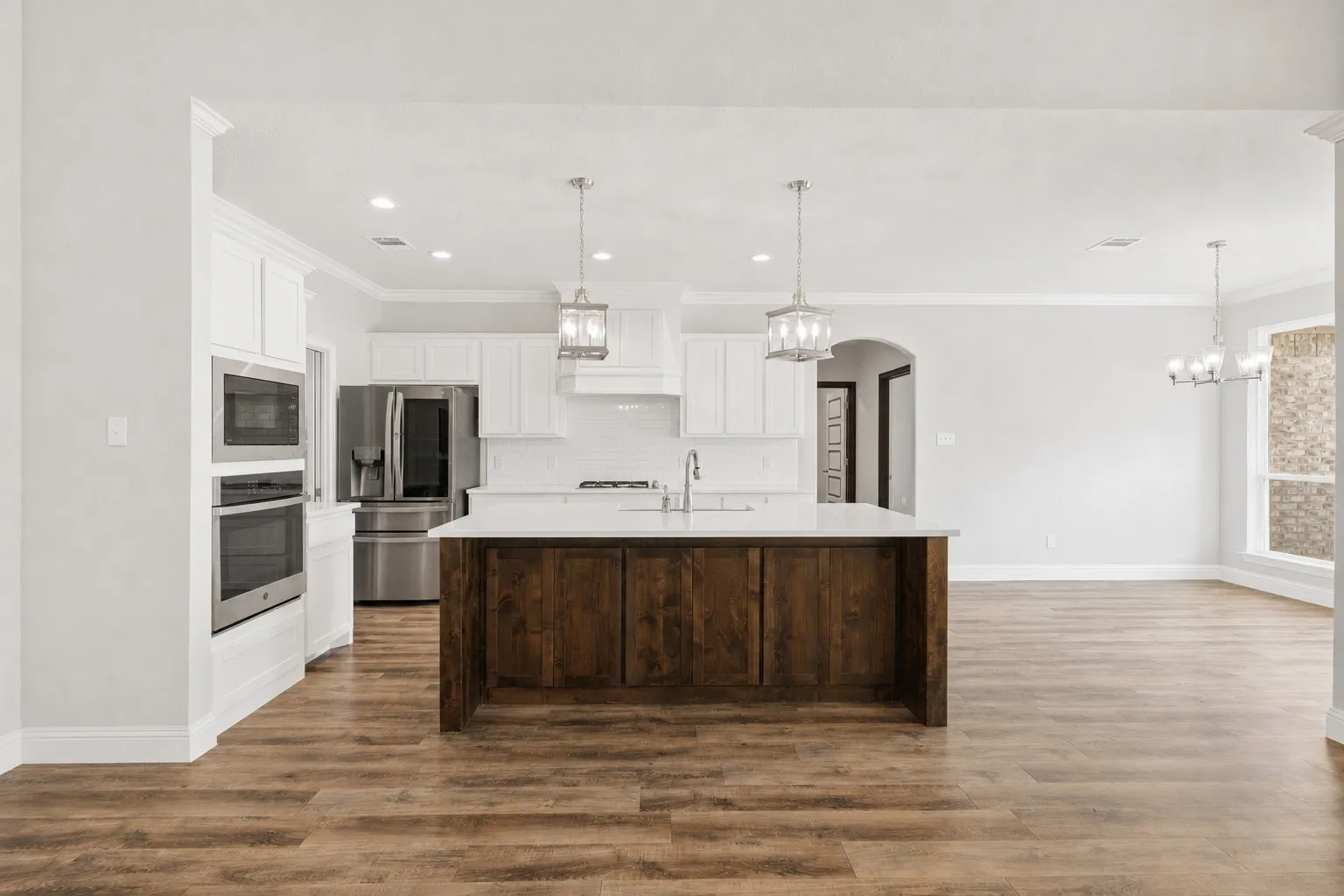 Kitchen features a stunning island with beautiful pendant lighting.