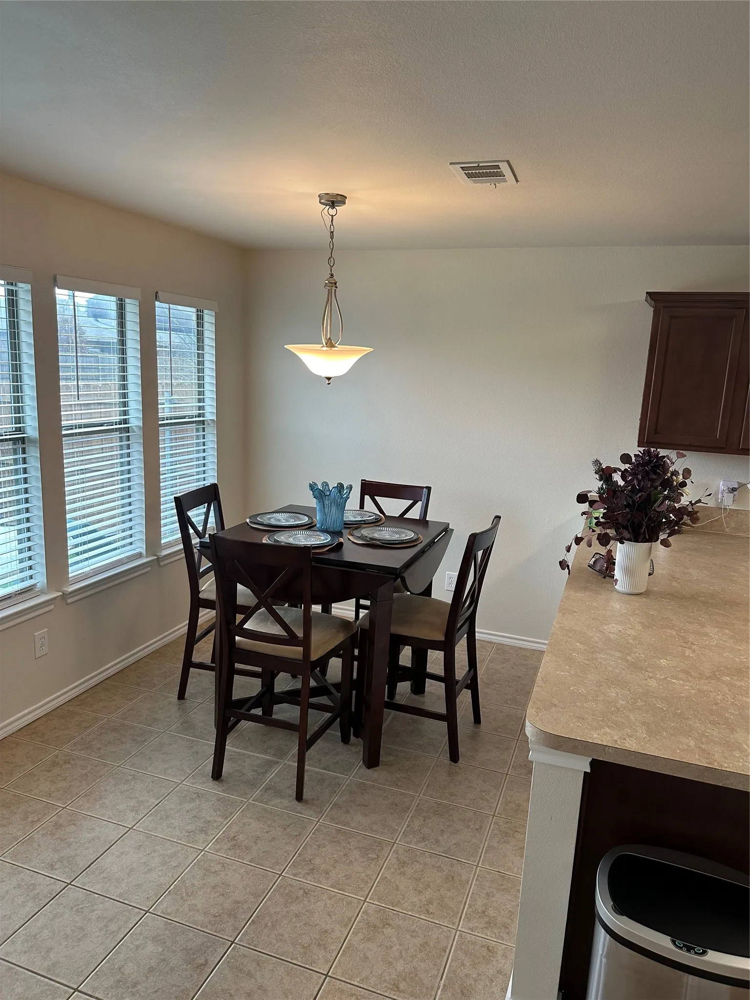 Dining area with light tile patterned flooring and baseboards