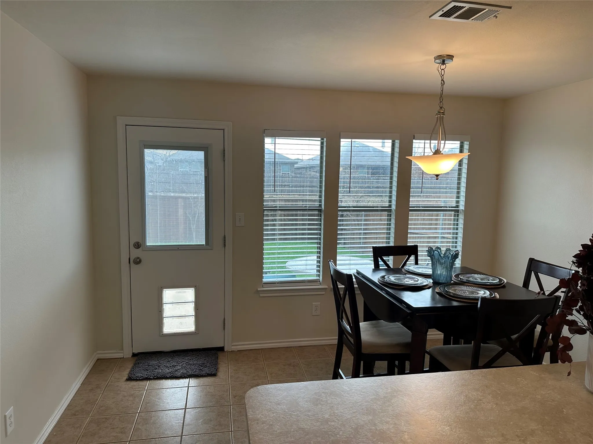 Dining space with baseboards and light tile patterned floors