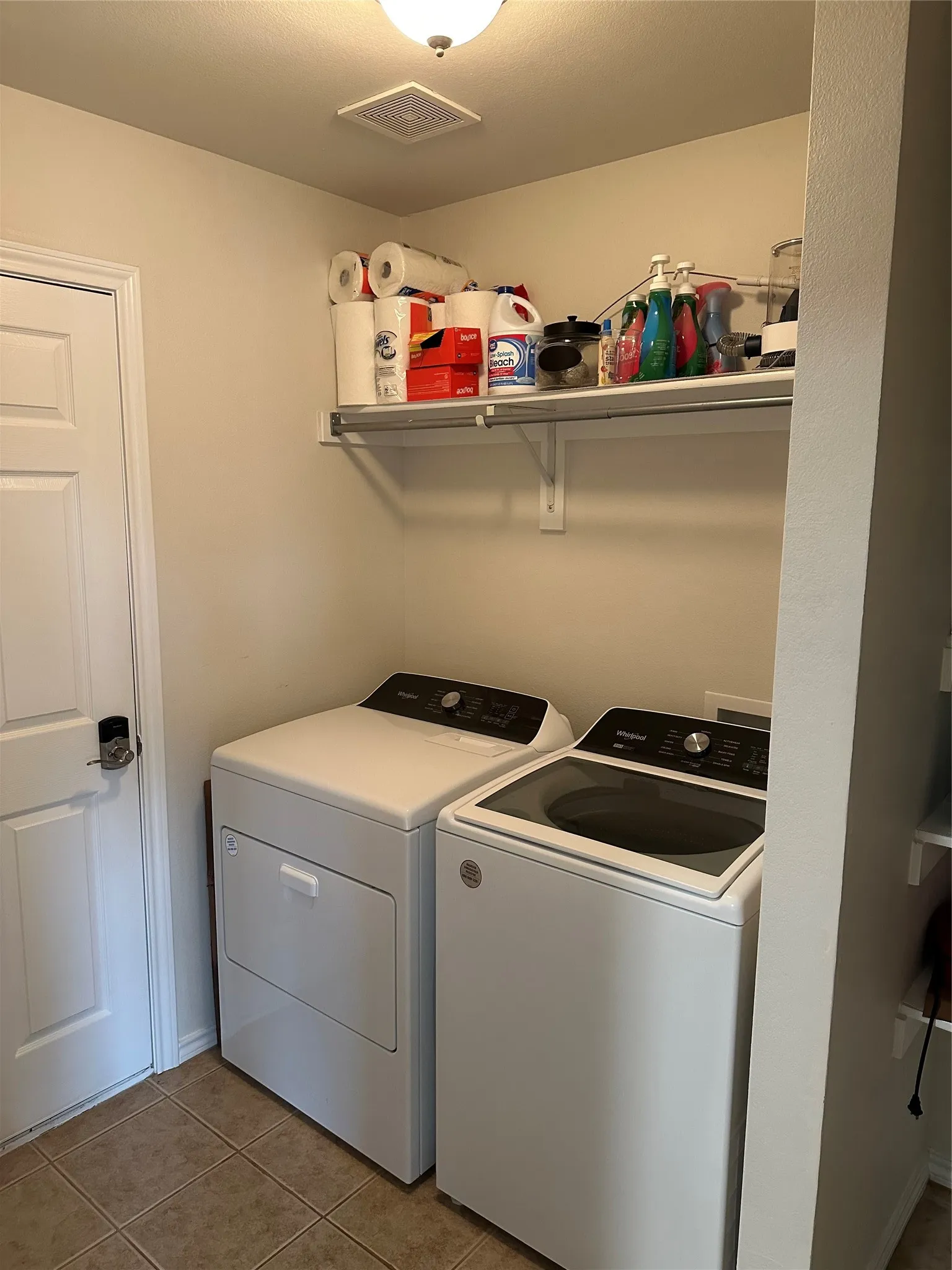 Laundry room featuring separate washer and dryer and light tile patterned floors