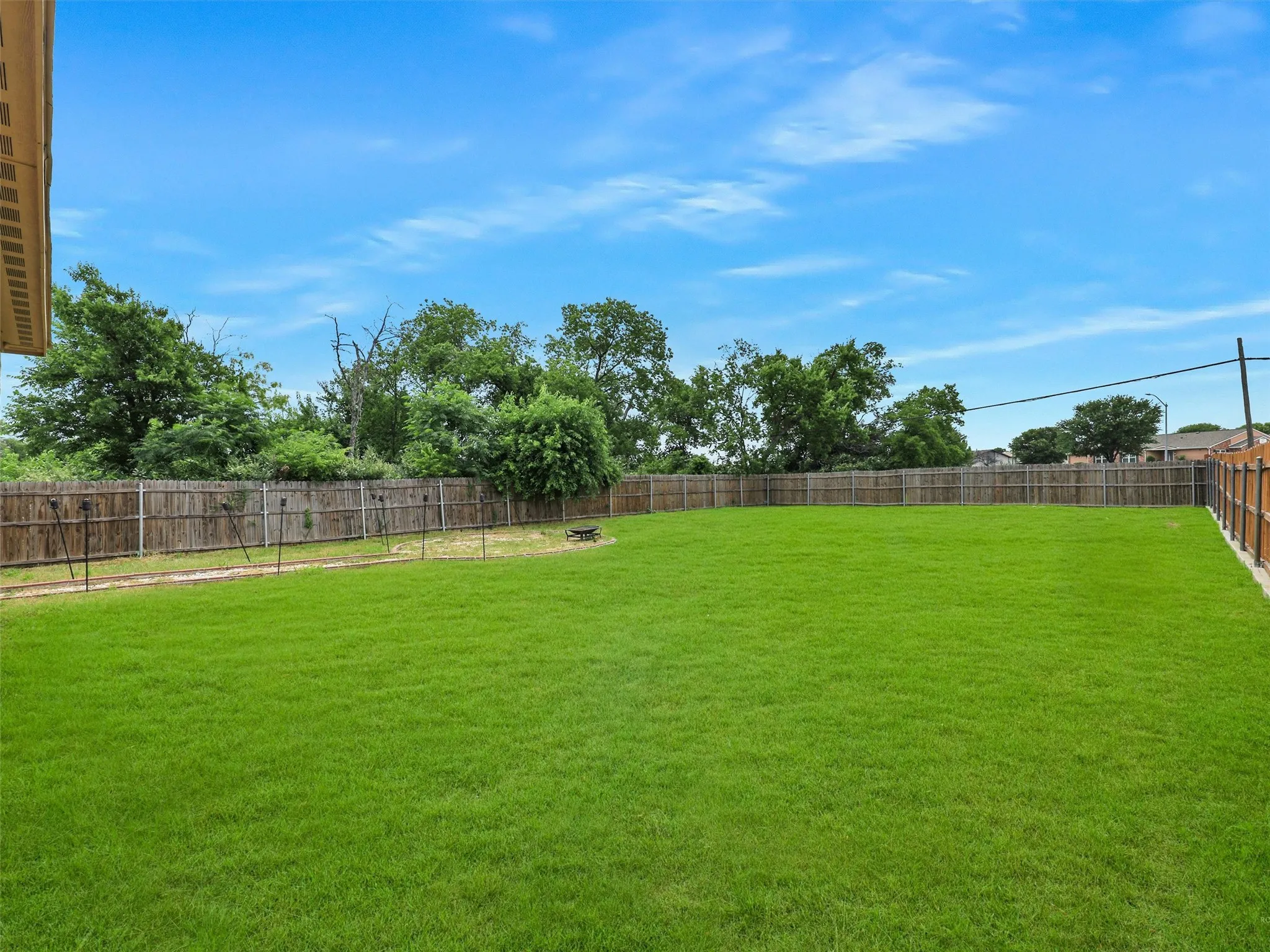 View of fenced backyard